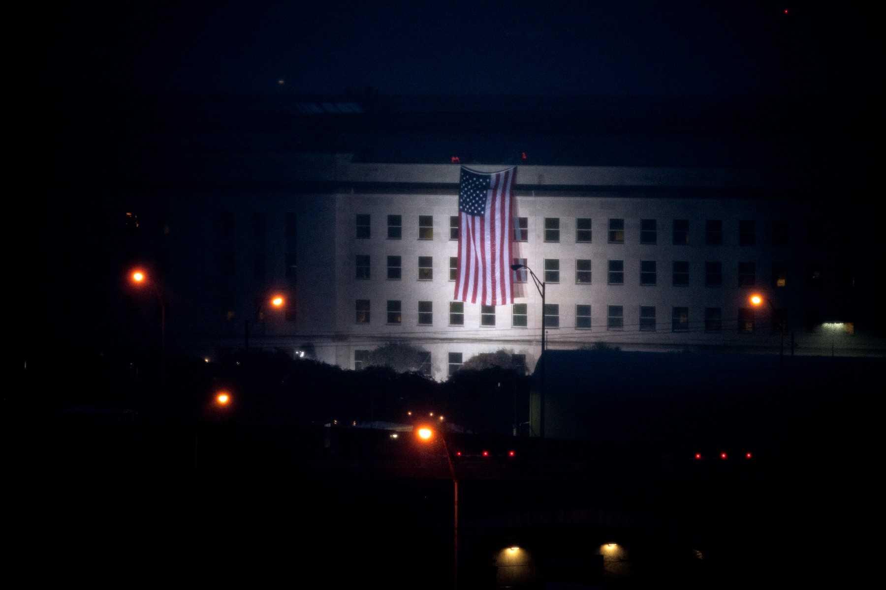 A US flag is unfurled from the Pentagon at dawn in Washington, DC, on Sept 11. Photo: AFP 