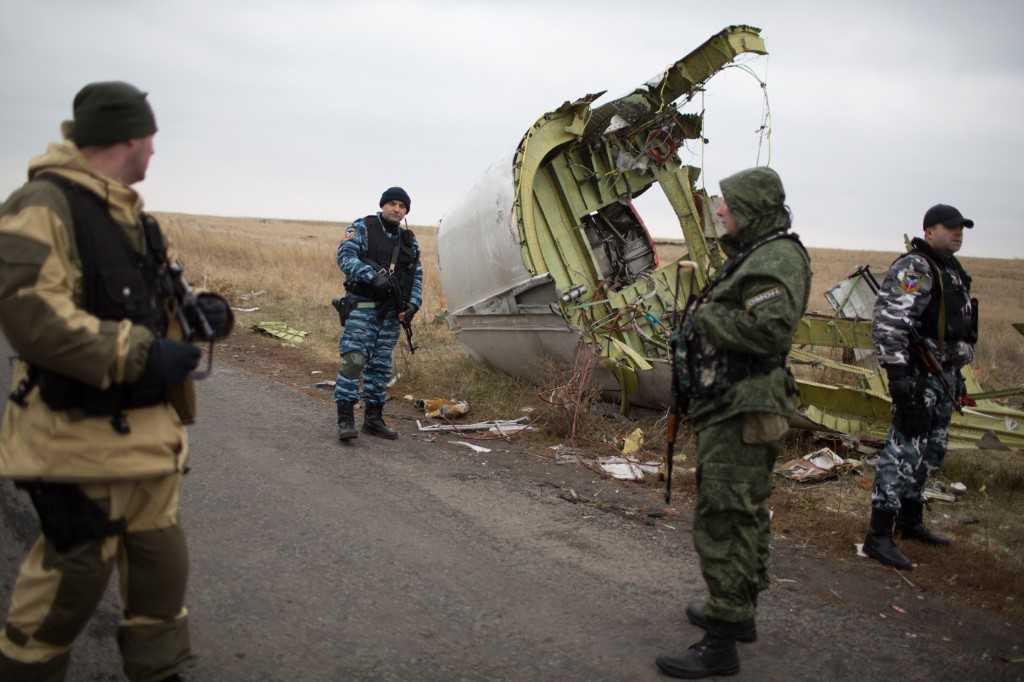 In this file photo taken on Nov 11, 2014, pro-Russian gunmen guard as Dutch investigators (unseen) arrive near parts of the Malaysia Airlines flight MH17 at the crash site near the Grabove village in eastern Ukraine. Photo: AFP