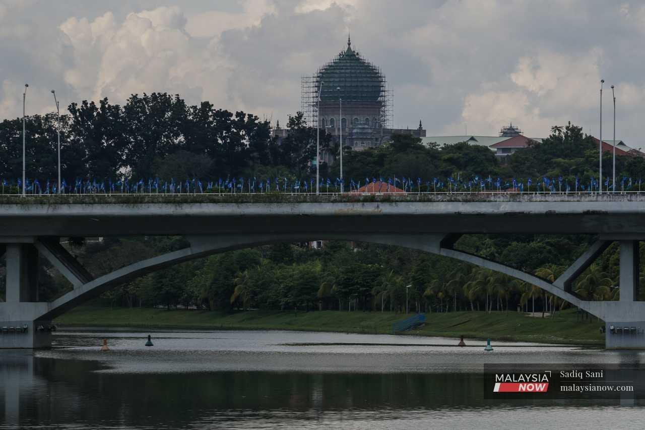 Barisan Nasional and Perikatan Nasional flags line a bridge near the Prime Minister's Office.