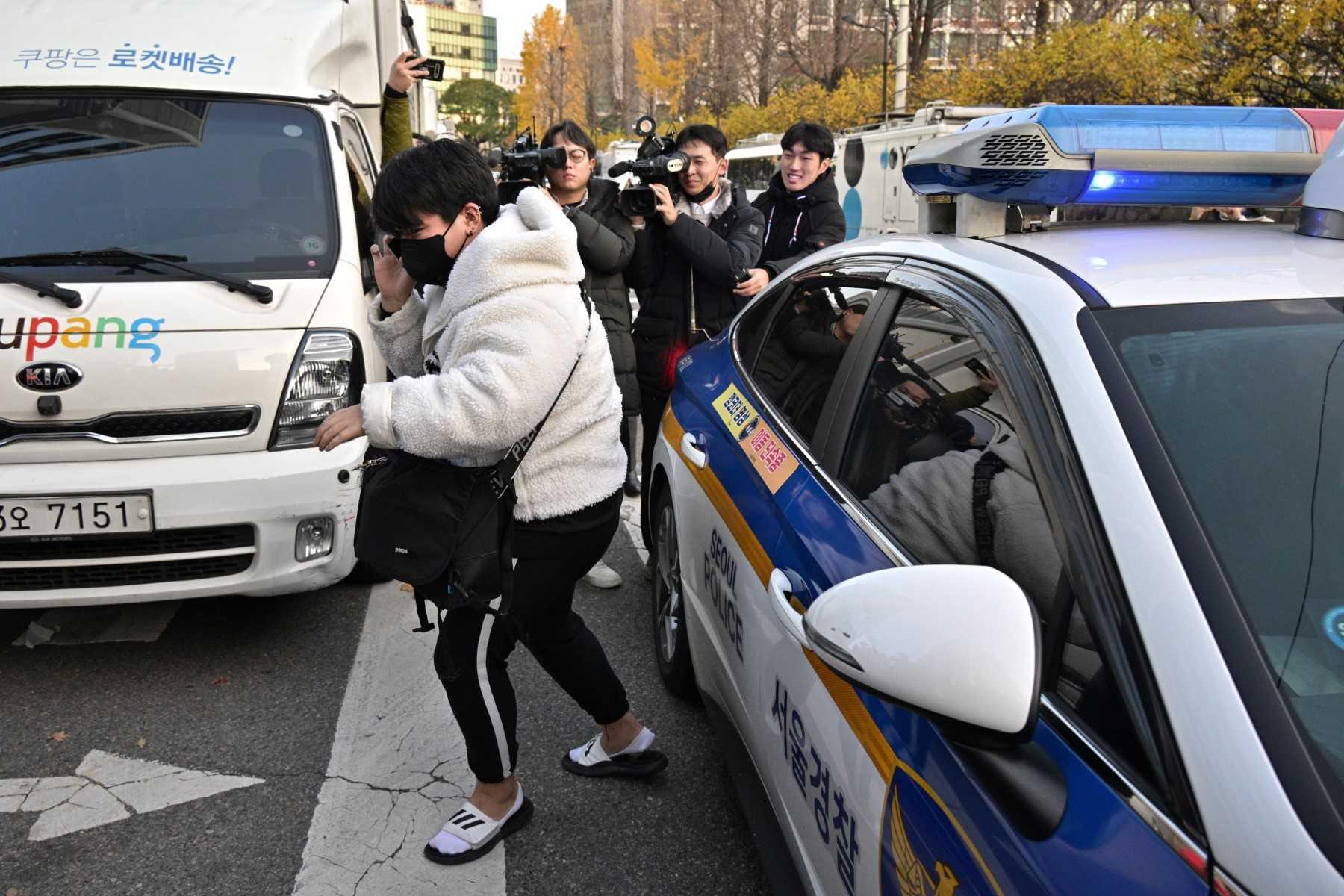 A student arrives after being given a lift by police to sit for the annual college entrance exam outside the Ehwa Girls Foreign Language High School in Seoul on Nov 17. Photo: AFP 