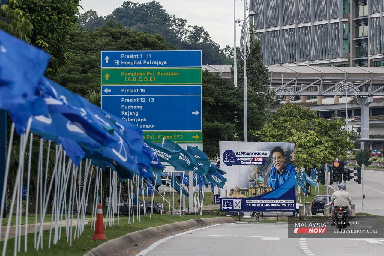 A picture of the incumbent, Barisan Nasional's Tengku Adnan Tengku Mansor, smiles down from a billboard in Presint 14, alongside a row of party flags.
