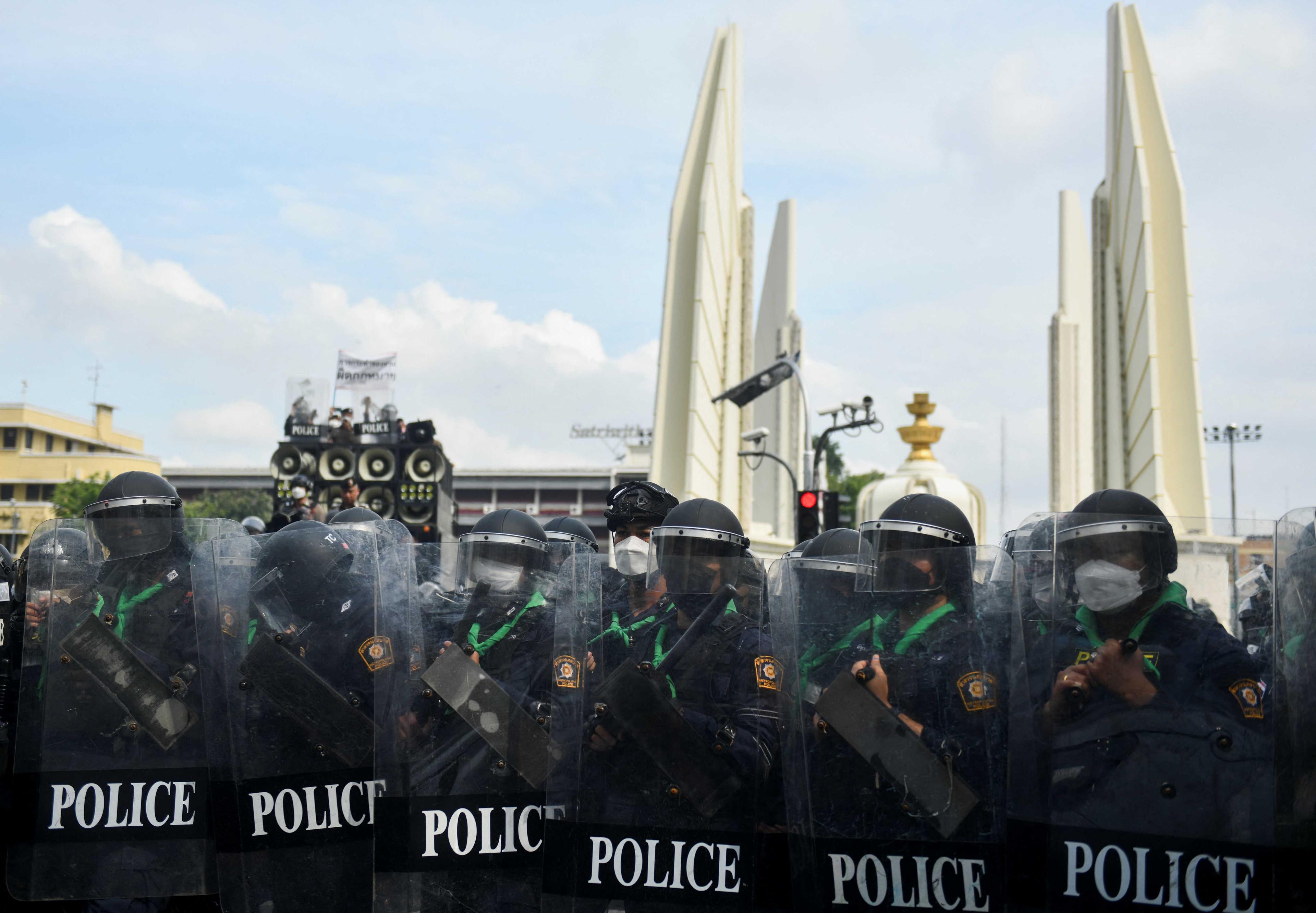Police officers holding shields stand guard during a protest against the Asia-Pacific Economic Cooperation Summit 2022, near the Democracy Monument in Bangkok, Thailand Nov 18. Photo: Reuters