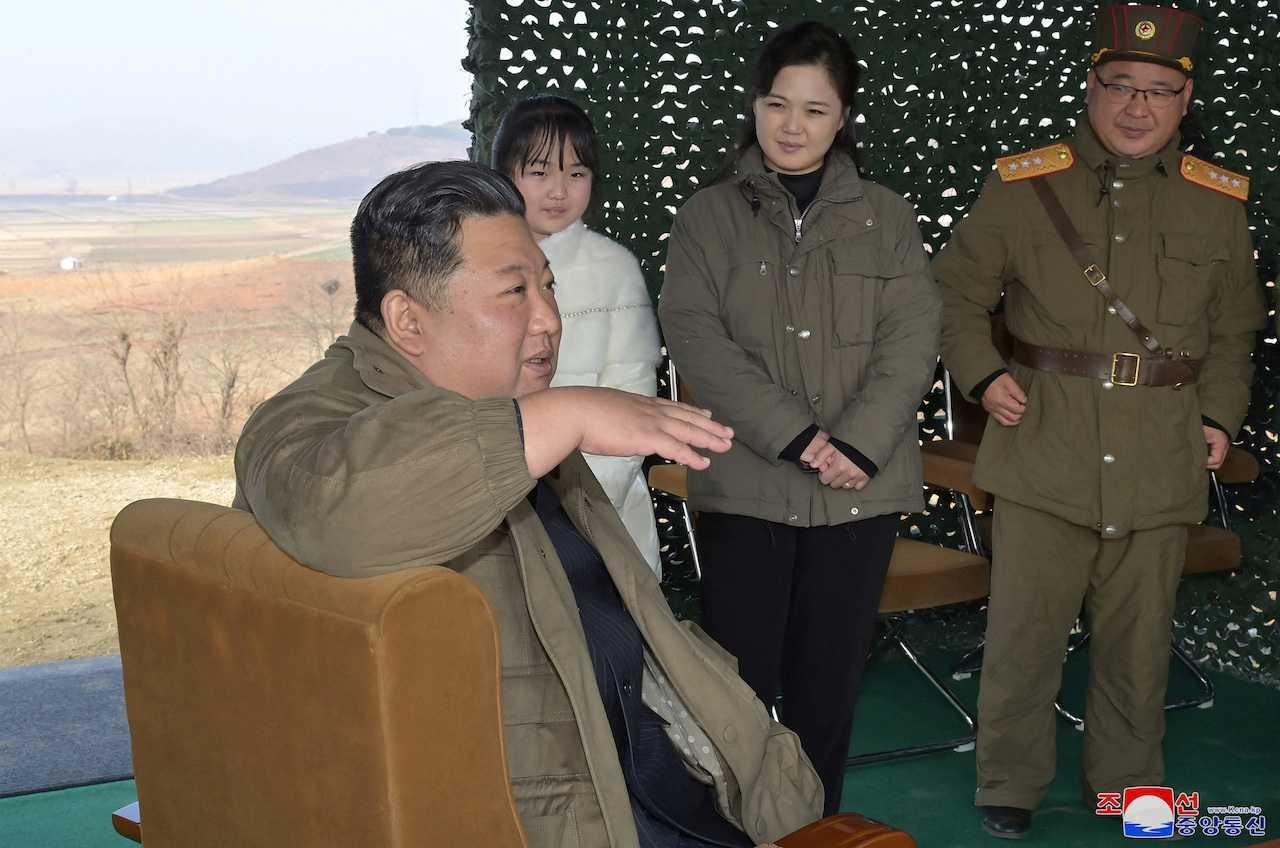 North Korean leader Kim Jong Un, with his wife Ri Sol Ju, speaks on the day of the launch of an intercontinental ballistic missile in this undated photo released on Nov 19 by North Korea's Korean Central News Agency. Photo: Reuters