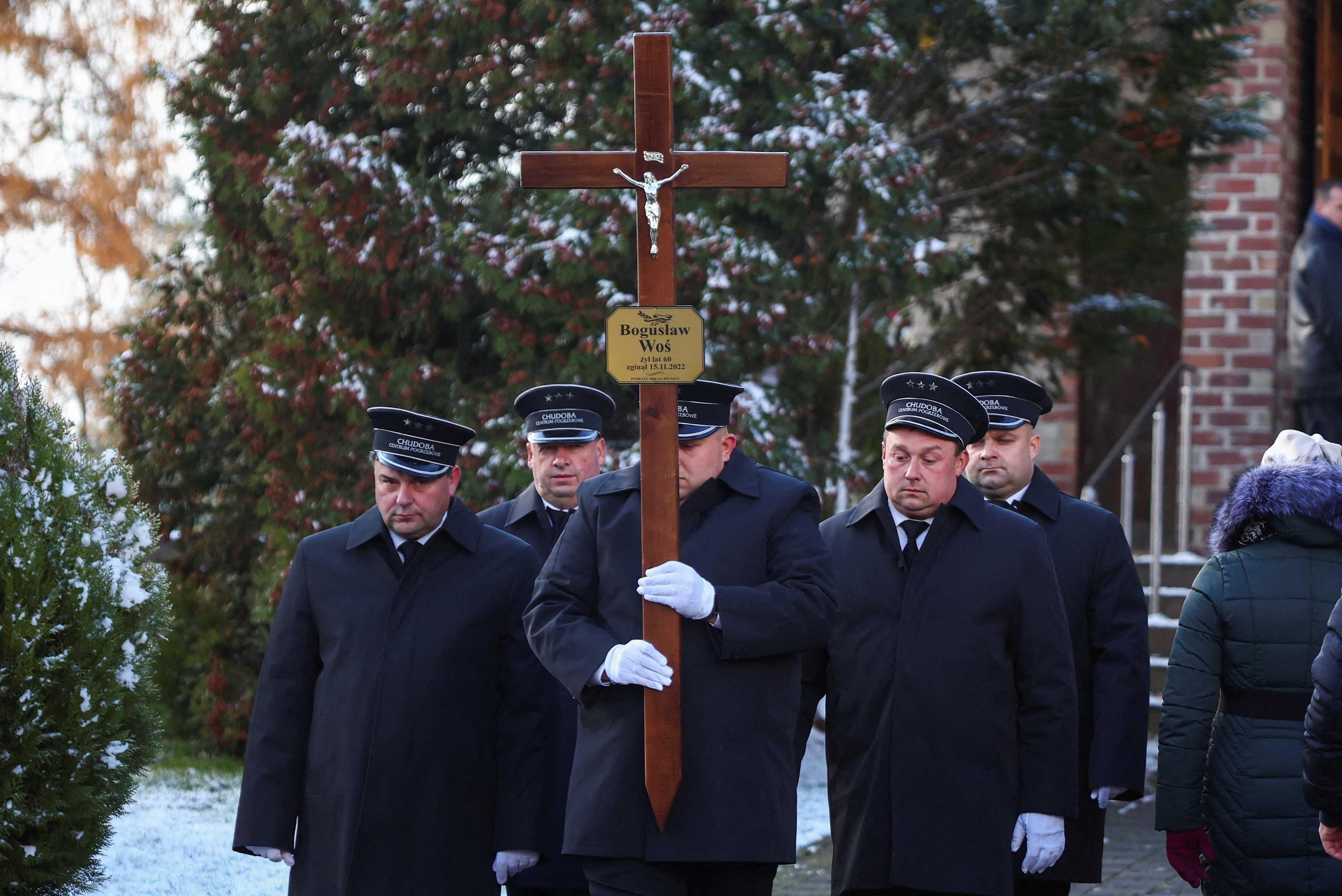 Morticians stand outside a church during the funeral of one of two victims of a missile that hit a southeastern Polish village near the border with Ukraine, in Przewodow, Poland on Nov 19. Photo: Reuters