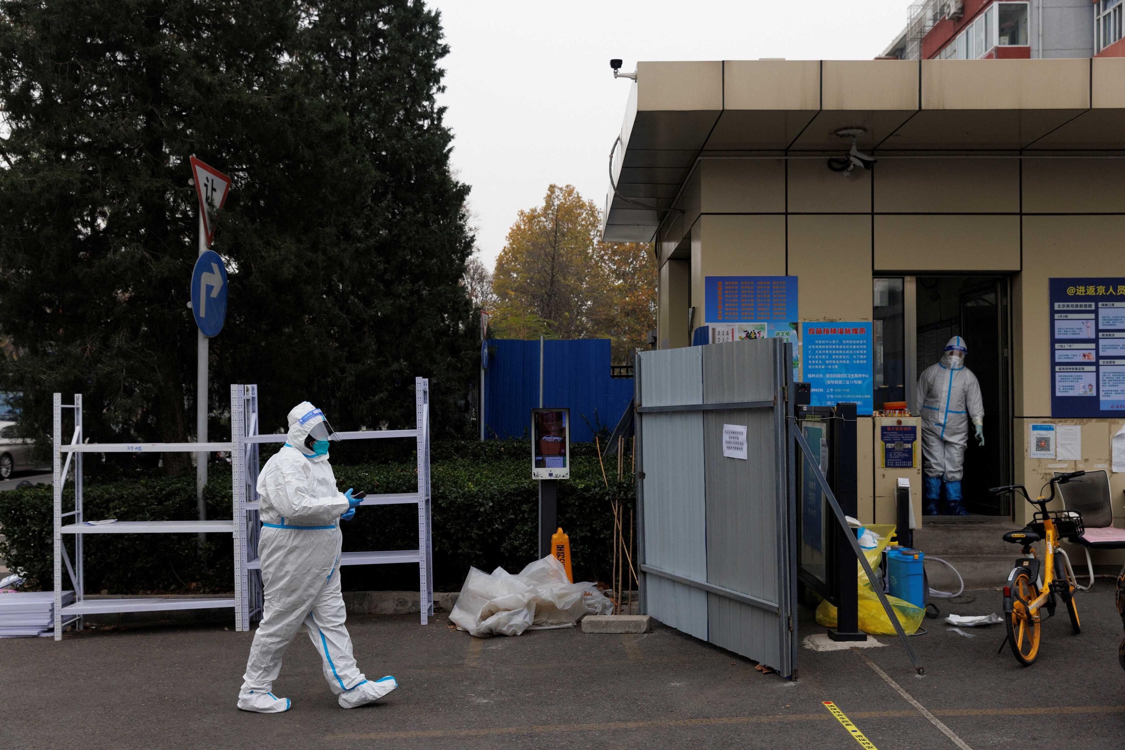 Pandemic prevention workers in protective suits are seen at the gate to a locked-down residential compound as outbreaks of Covid-19 continue in Beijing, China on Nov 18. Photo: Reuters