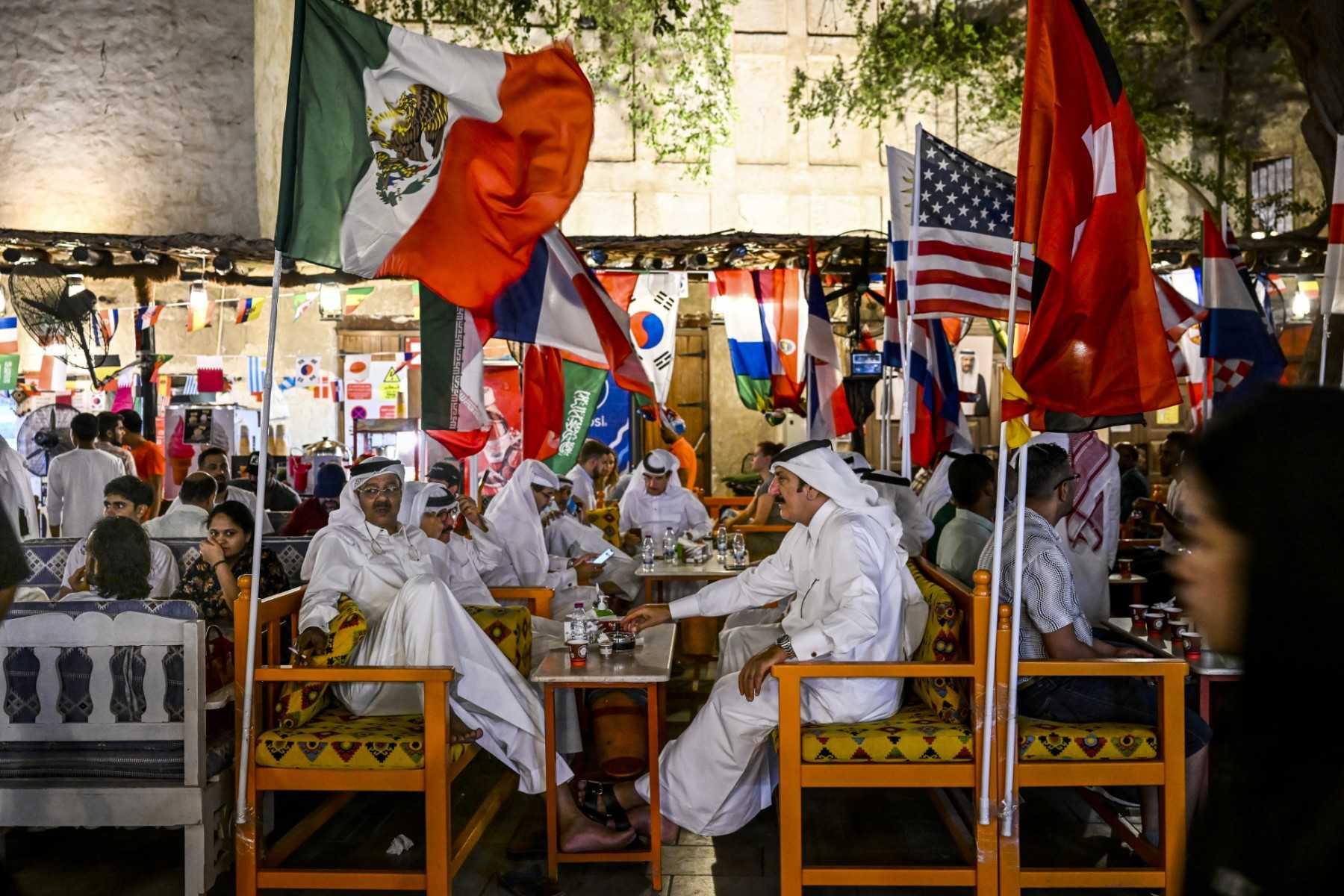 People drink coffee at the Souq Waqif marketplace in Doha on Nov 19, ahead of the Qatar 2022 World Cup football tournament. Photo: AFP