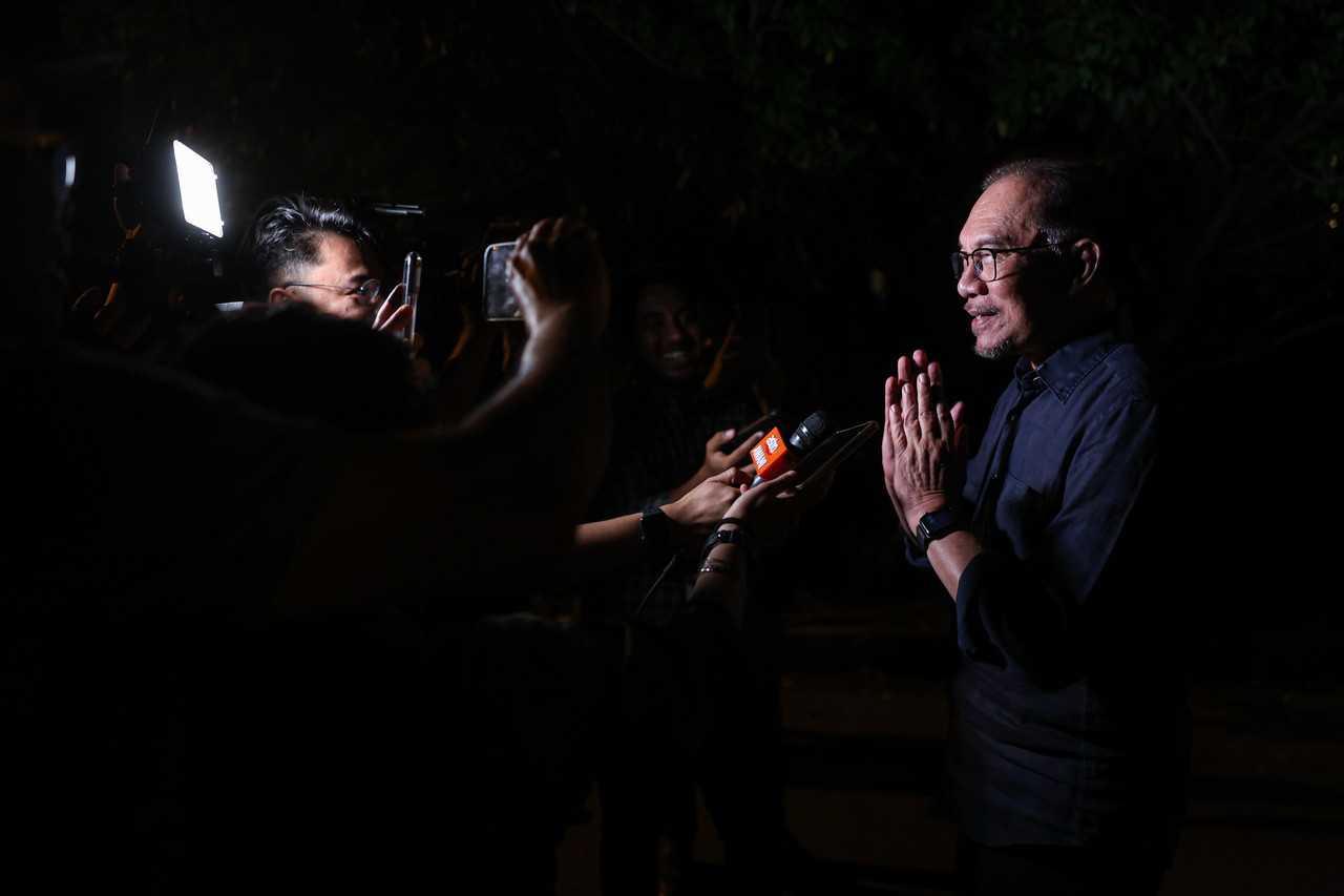 Pakatan Harapan chairman Anwar Ibrahim speaks at a press conference in front of his house in Kajang last night. Photo: Bernama