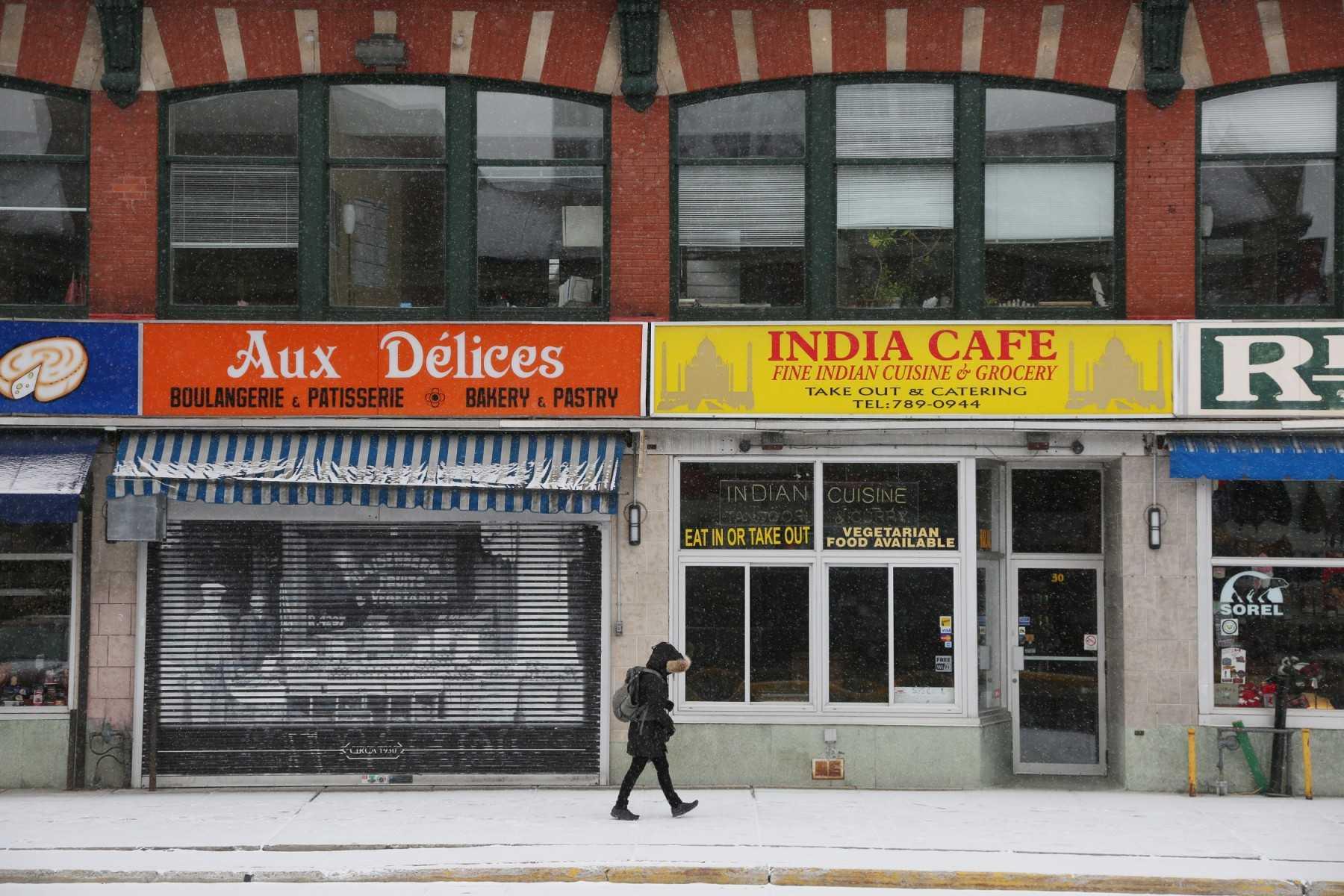 A pedestrian walks along an empty street and closed shops in the Byward Market March 23, 2020 in Ottawa, Canada. Photo: AFP