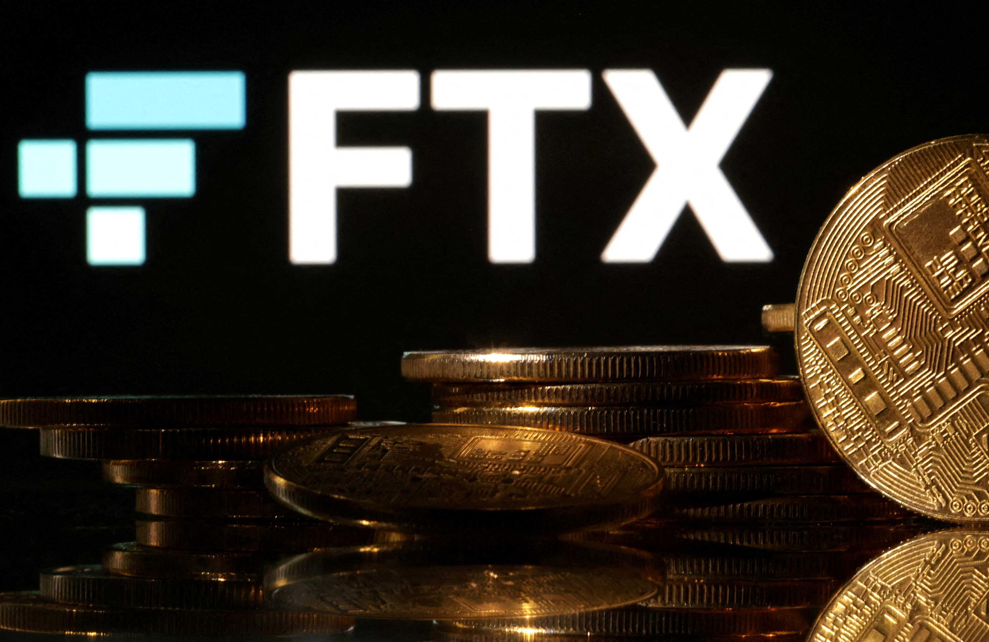 Representations of cryptocurrencies are seen in front of displayed FTX logo in this illustration taken Nov 10. Photo: Reuters