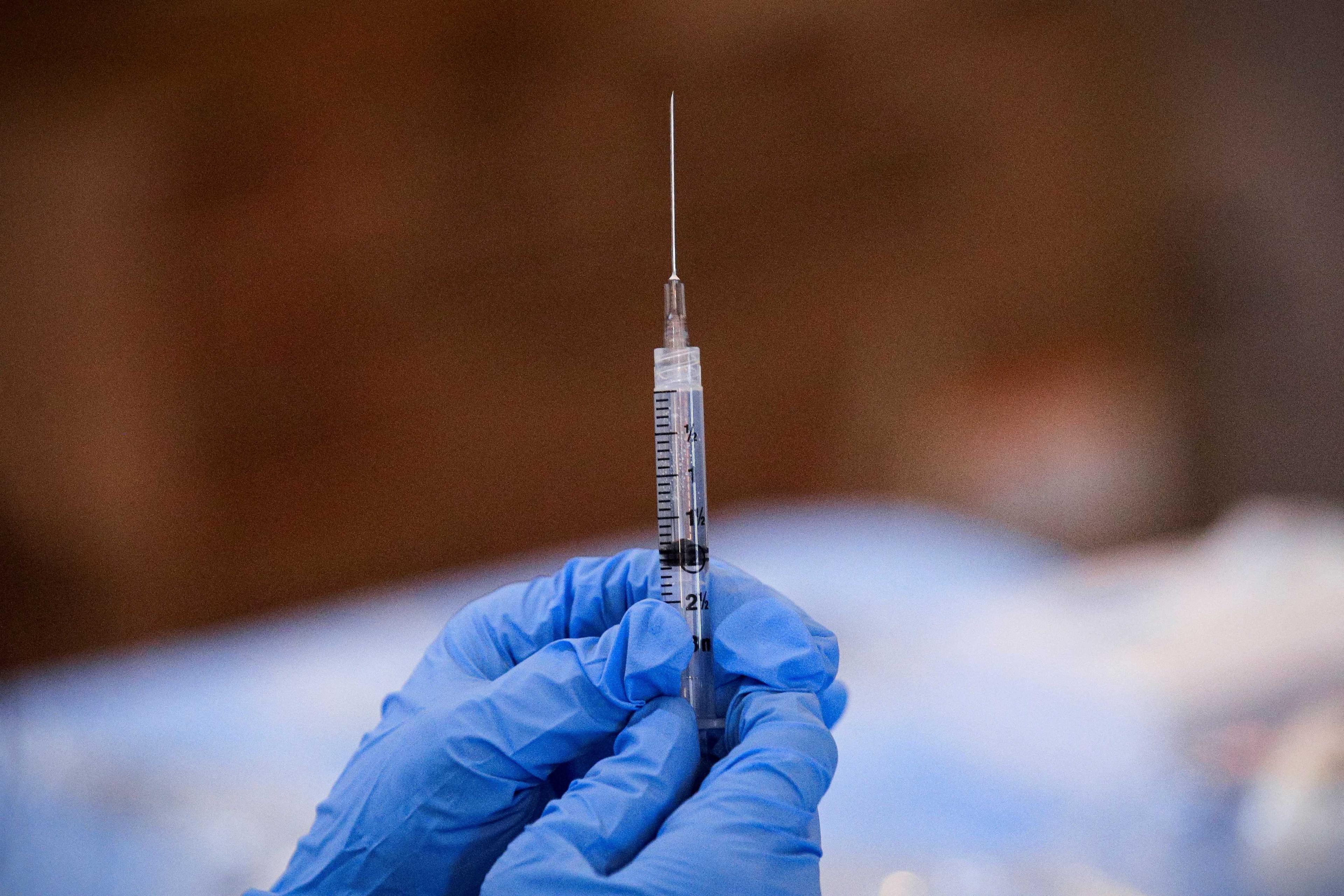 A syringe is filled with a dose of Pfizer's Covid-19 vaccine at a community vaccination centre in, New York, US, Feb 23, 2021. Photo: Reuters