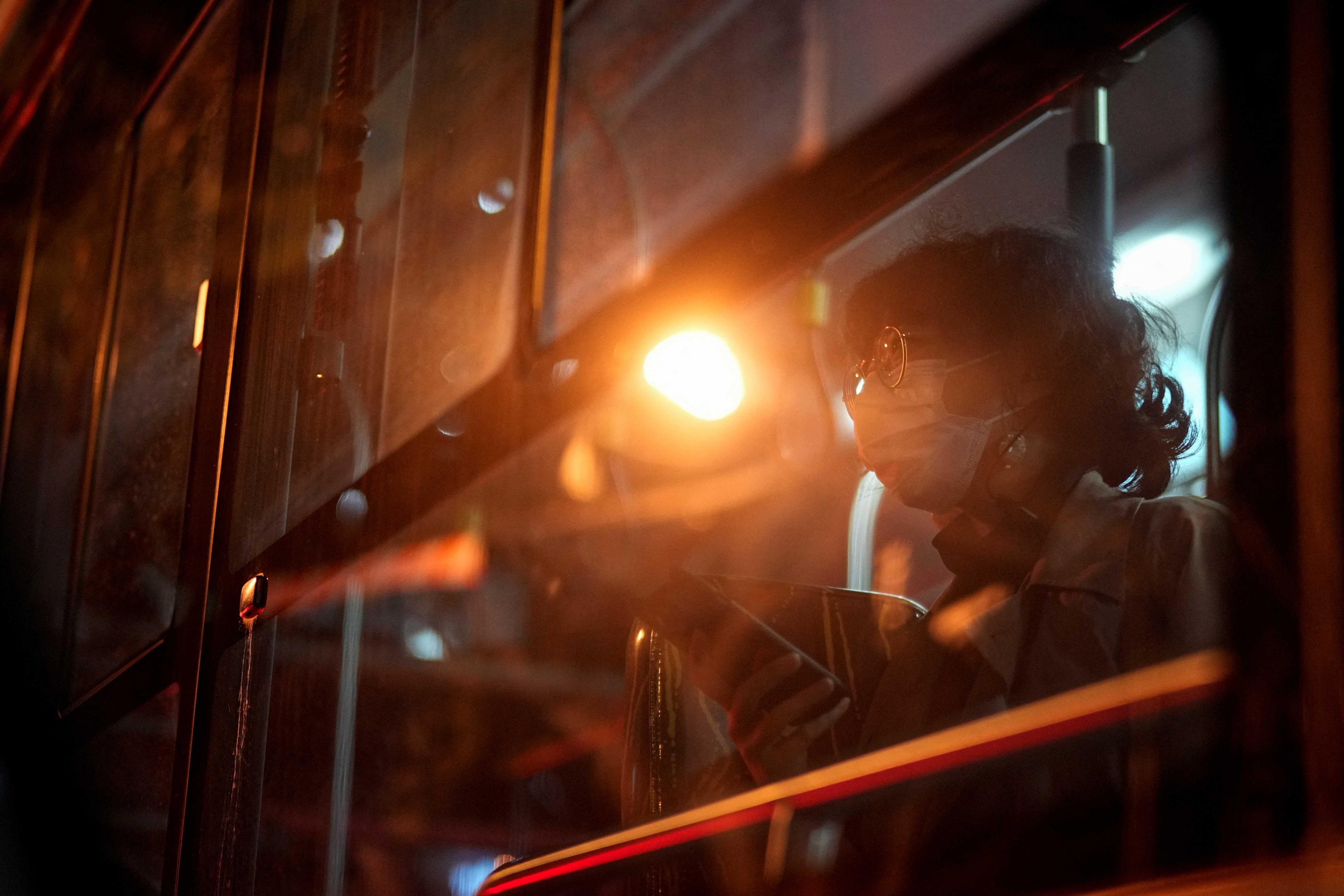A woman wearing a face mask rides on a bus, following the Covid-19 outbreak in Shanghai, China, Nov 24. Photo: Reuters