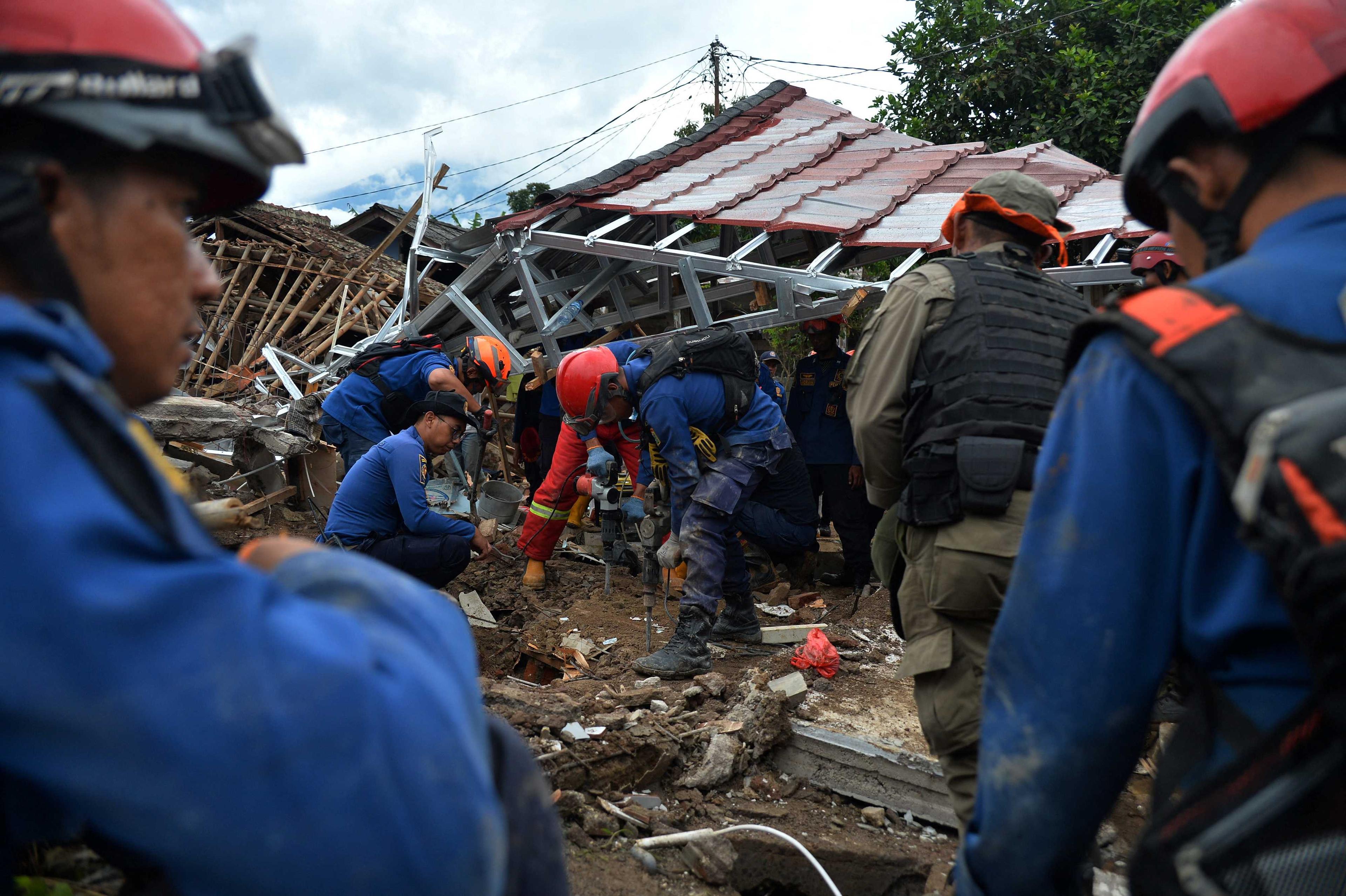 Rescuers drill on the rubble as they look for a missing person at a building collapsed in Monday's earthquake, in Cianjur, West Java province, Indonesia, Nov 24, in this photo taken by Antara Foto. Photo: Reuters