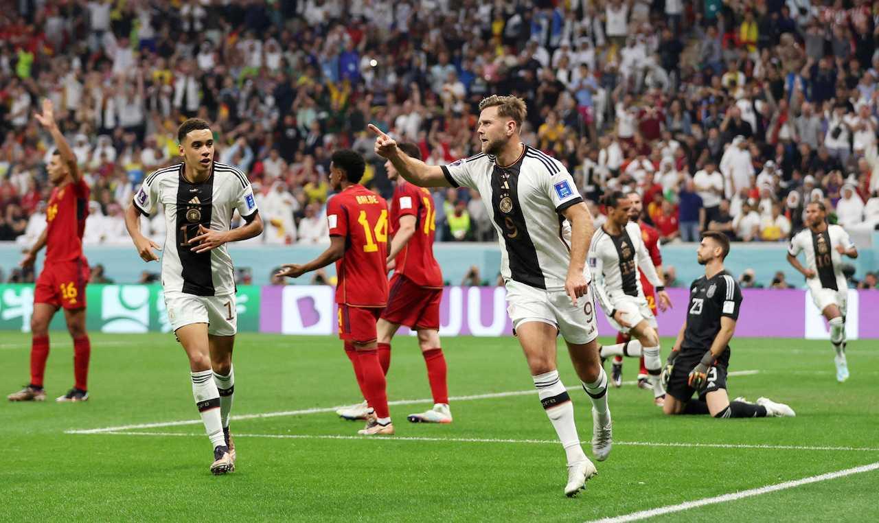 Germany's Niclas Fullkrug celebrates scoring their first goal with Jamal Musiala during their Group E match with Spain at Al Bayt Stadium, Al Khor, Qatar, Nov 27. Photo: Reuters