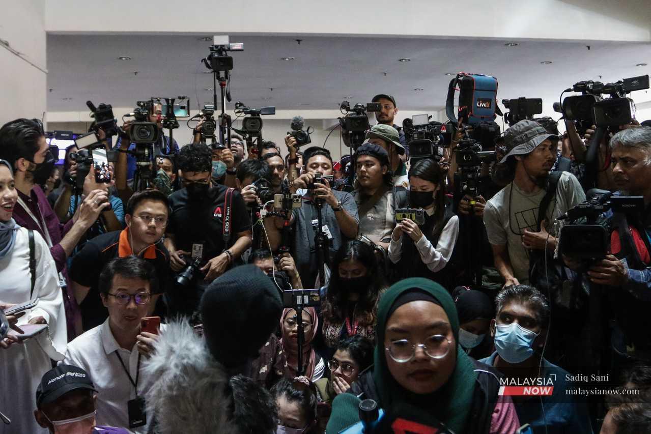 Reporters gather outside the Seri Pacific Hotel in Kuala Lumpur after an announcement by Pakatan Harapan leaders of a press conference following a meeting with representatives from Barisan Nasional. 
