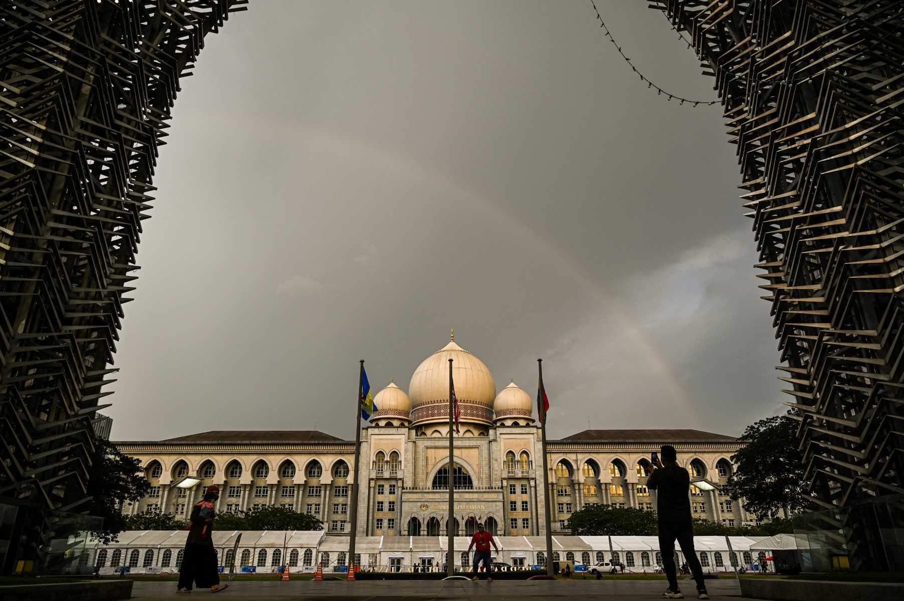 People take pictures outside the Palace of Justice in Putrajaya which houses the Court of Appeal and Federal Court. Photo: AFP
