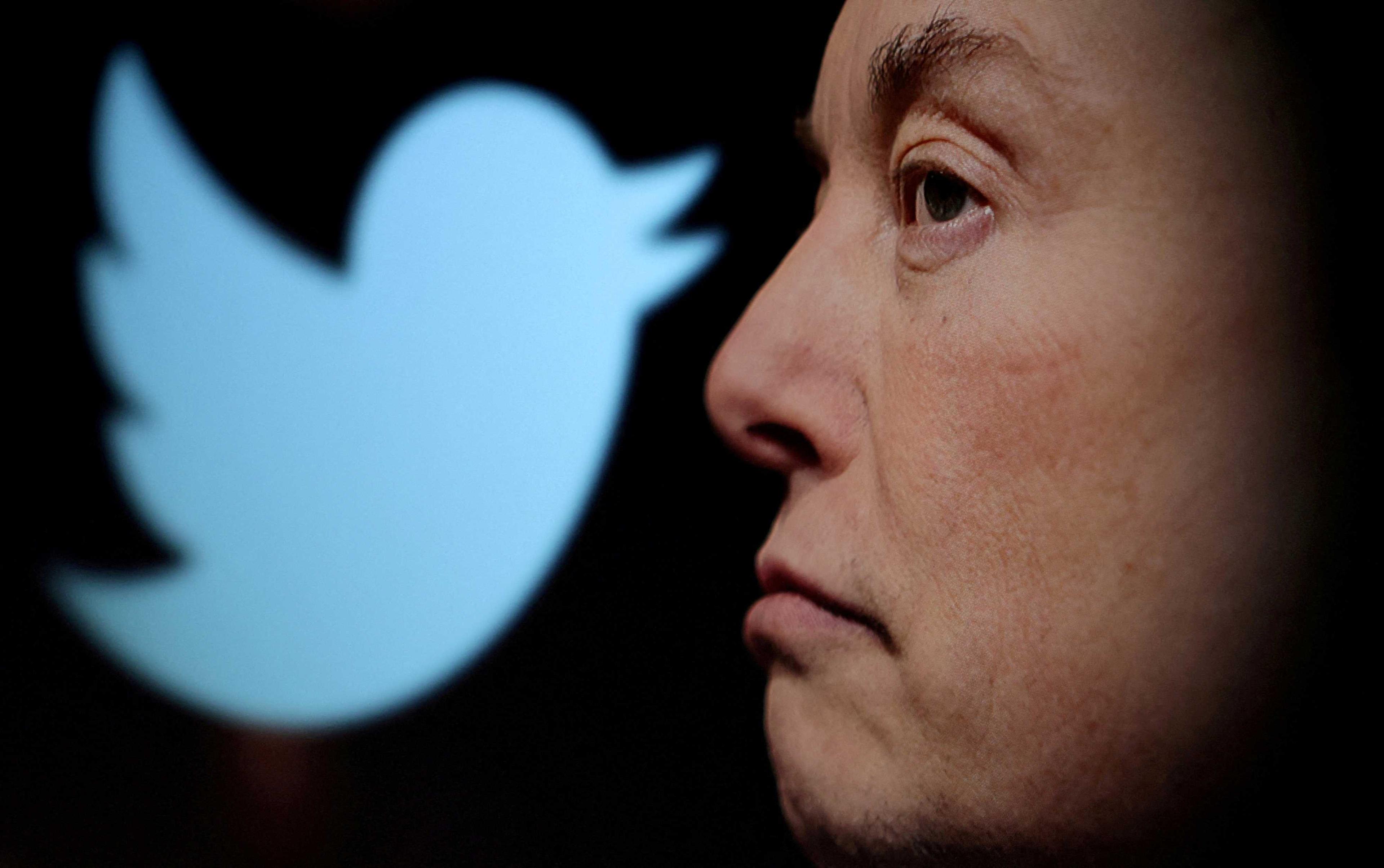Twitter logo and a photo of Elon Musk are displayed through magnifier in this illustration taken Oct 27. Photo: Reuters