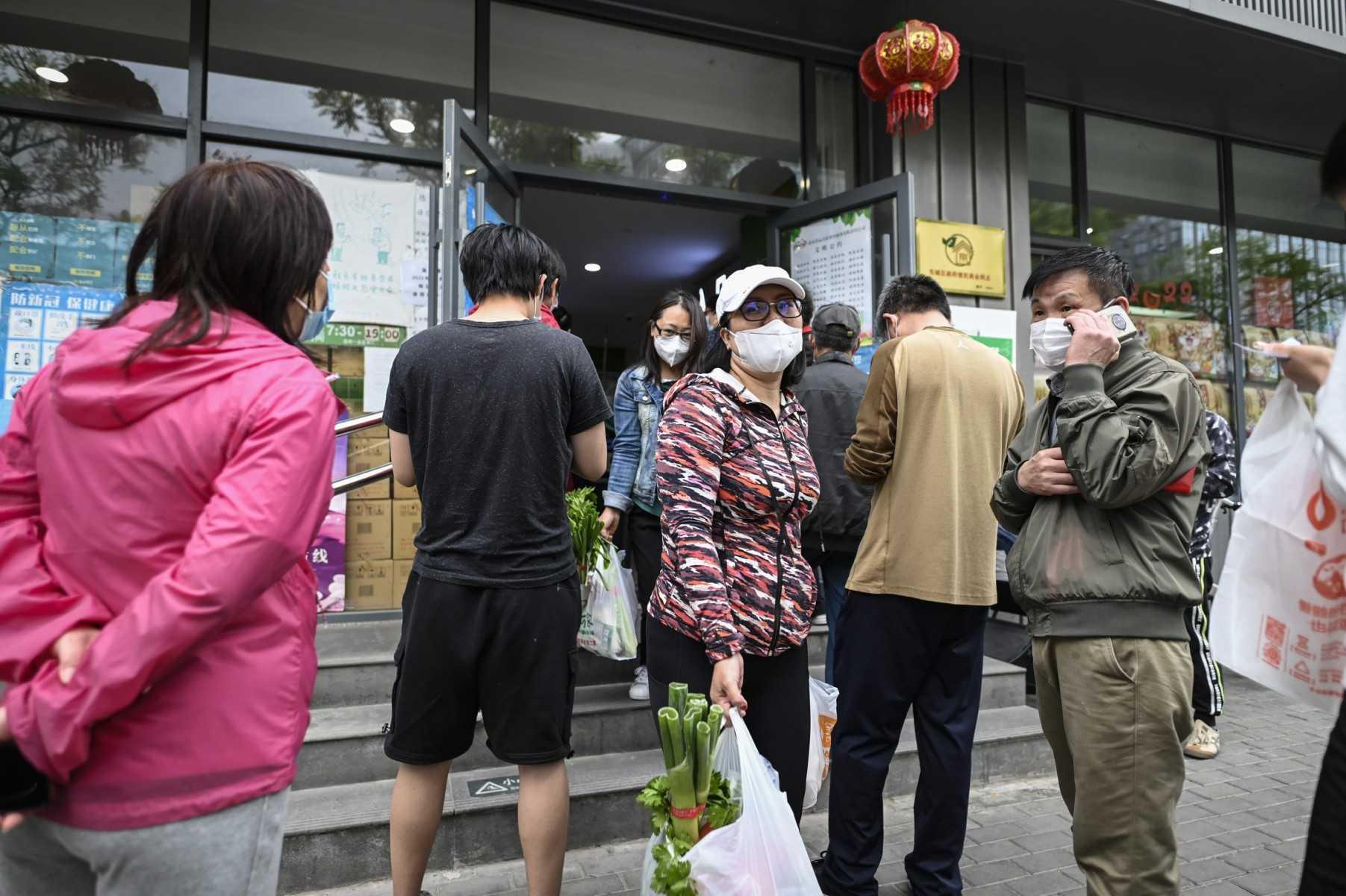 People buy food and household items at a supermarket in Beijing on May 12. Photo: AFP 