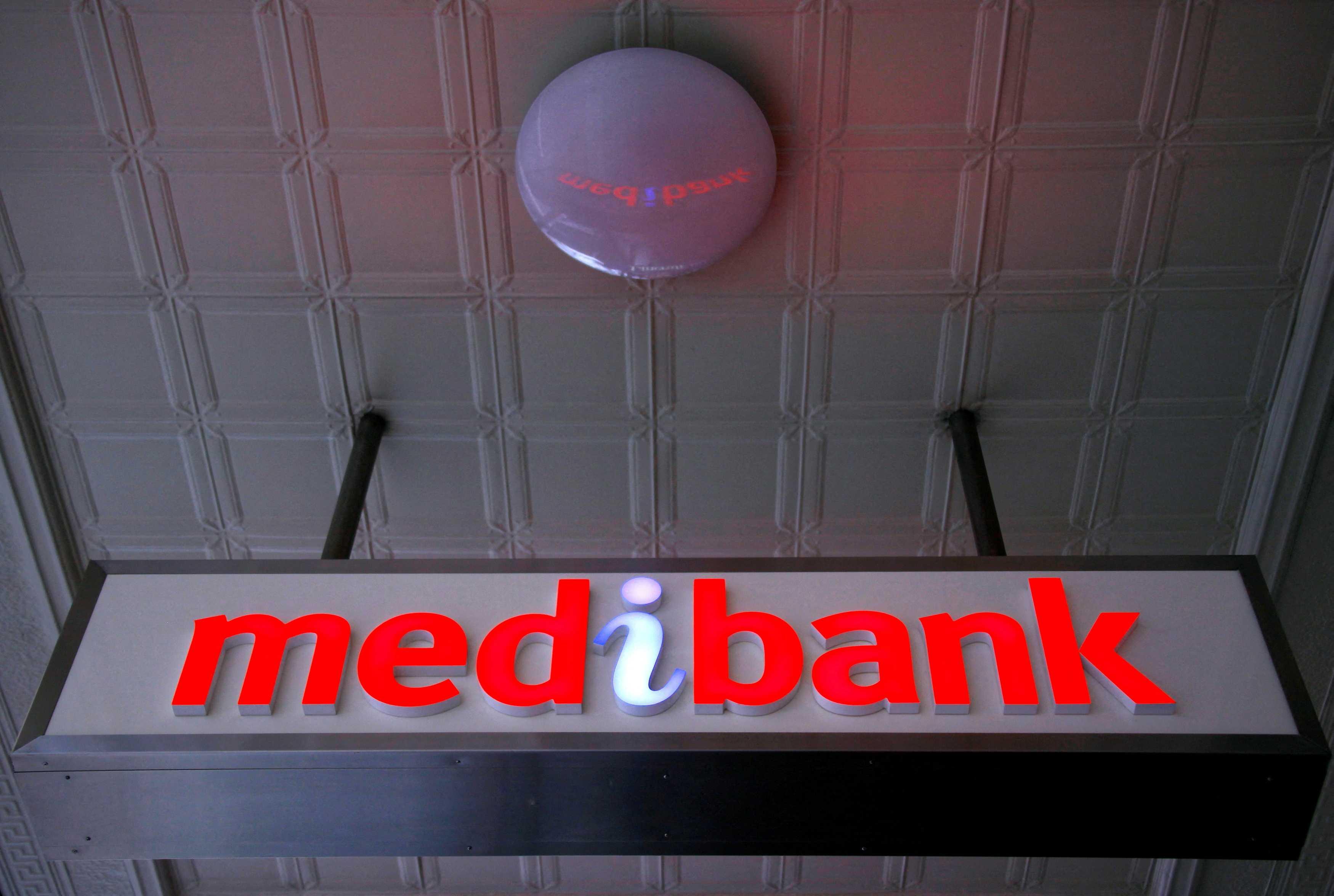 An illuminated sign is seen outside a branch of the Australian health insurer Medibank Private in Sydney Oct 20, 2014. Photo: Reuters