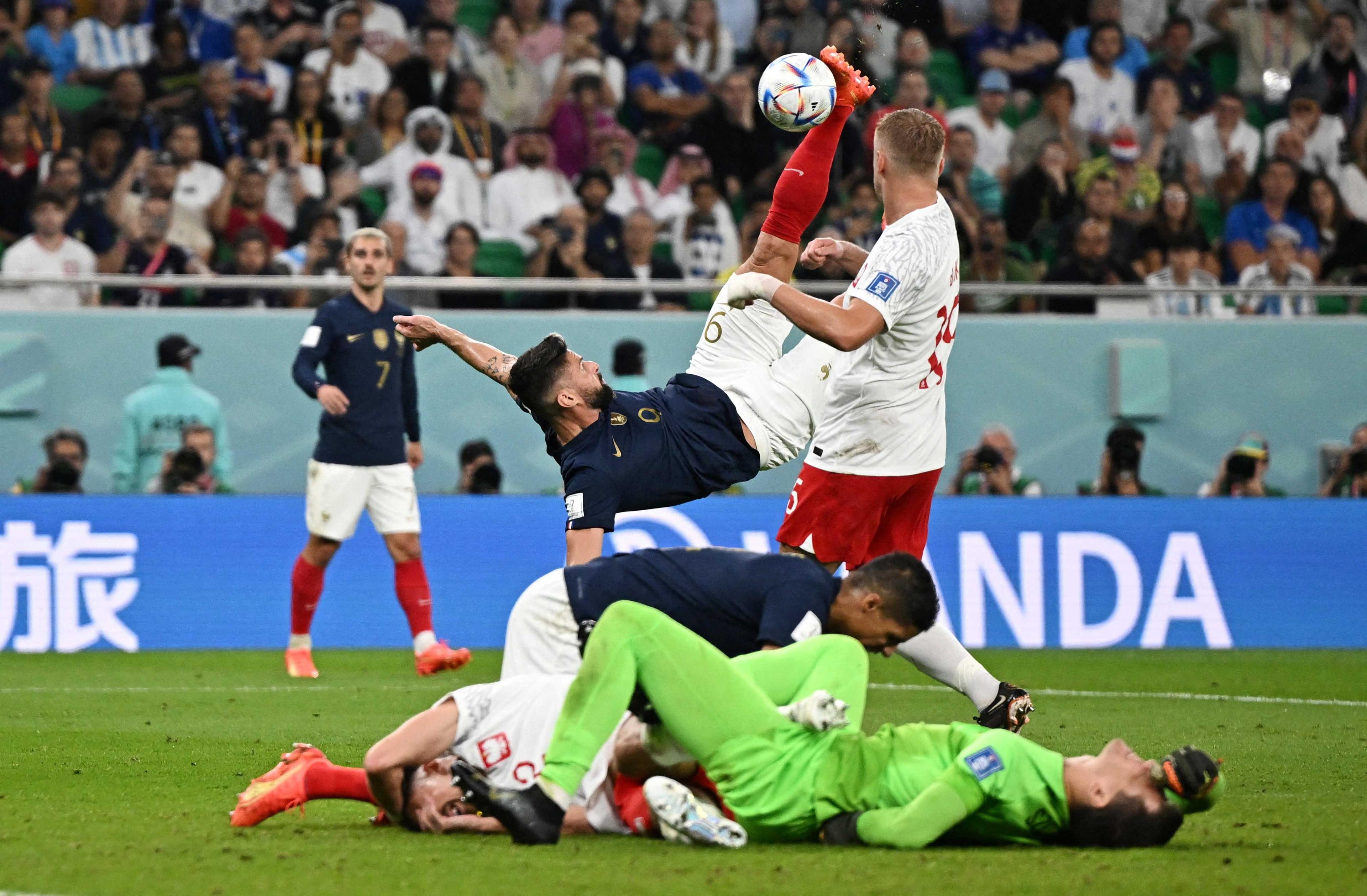 France's Olivier Giroud scores a disallowed goal as Poland's Wojciech Szczesny reacts after sustaining an injury at Al Thumama Stadium in Doha, Qatar, Dec 4. Photo: Reuters