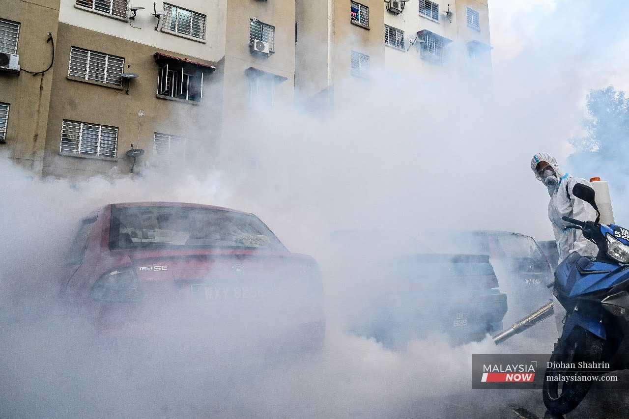 Volunteers conduct fogging activities to combat the spread of dengue in this file photo.