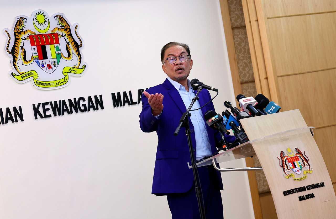 Prime Minister Anwar Ibrahim speaks at his first press conference as finance minister in Putrajaya today. Photo: Bernama
