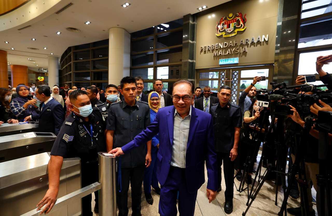 Prime Minister Anwar Ibrahim clocks in for duty at the finance ministry in Putrajaya today. Photo: Bernama