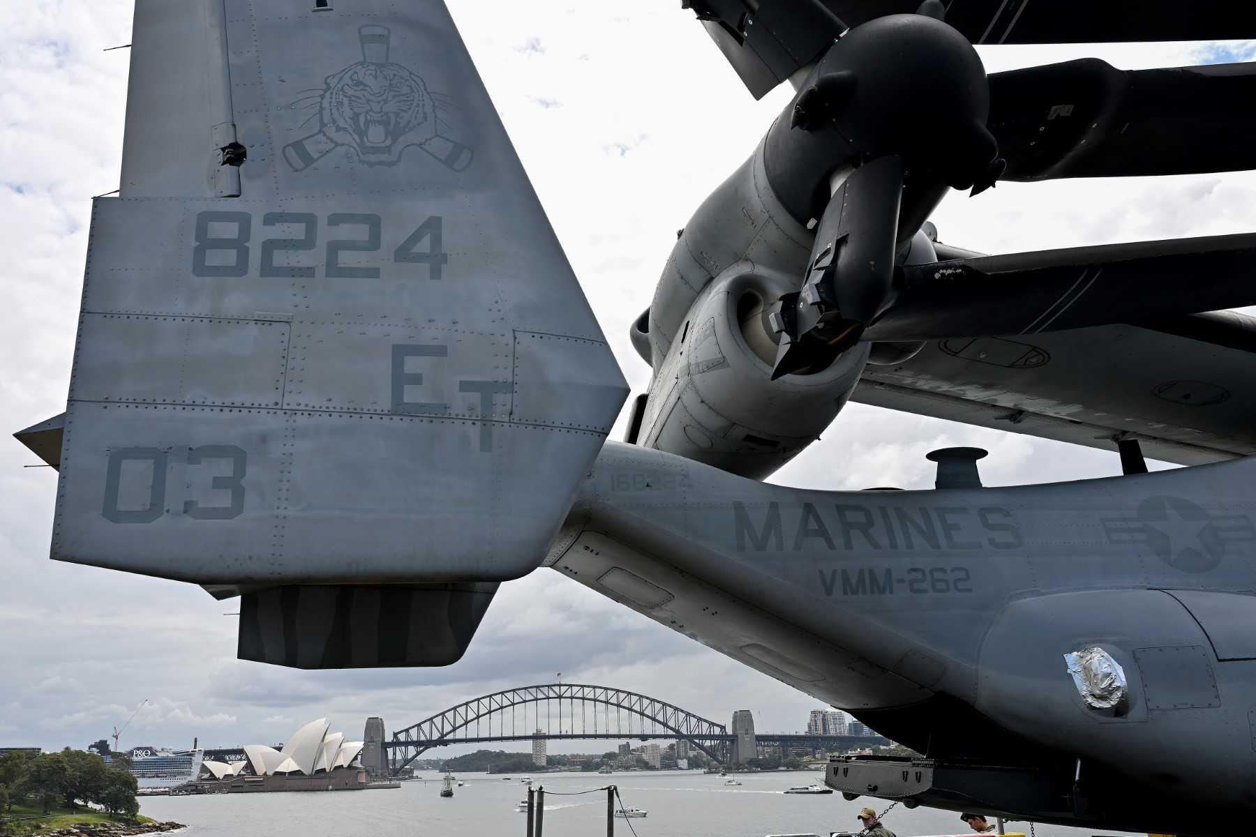 Australia’s landmark Opera House and the Harbour Bridge are seen past an MV-22 Osprey tilt-rotor aircraft on the flight deck of the US Navy’s USS Tripoli (LHA-7) amphibious assault ship while docked at fleet base in Sydney on Nov 4. Photo: AFP