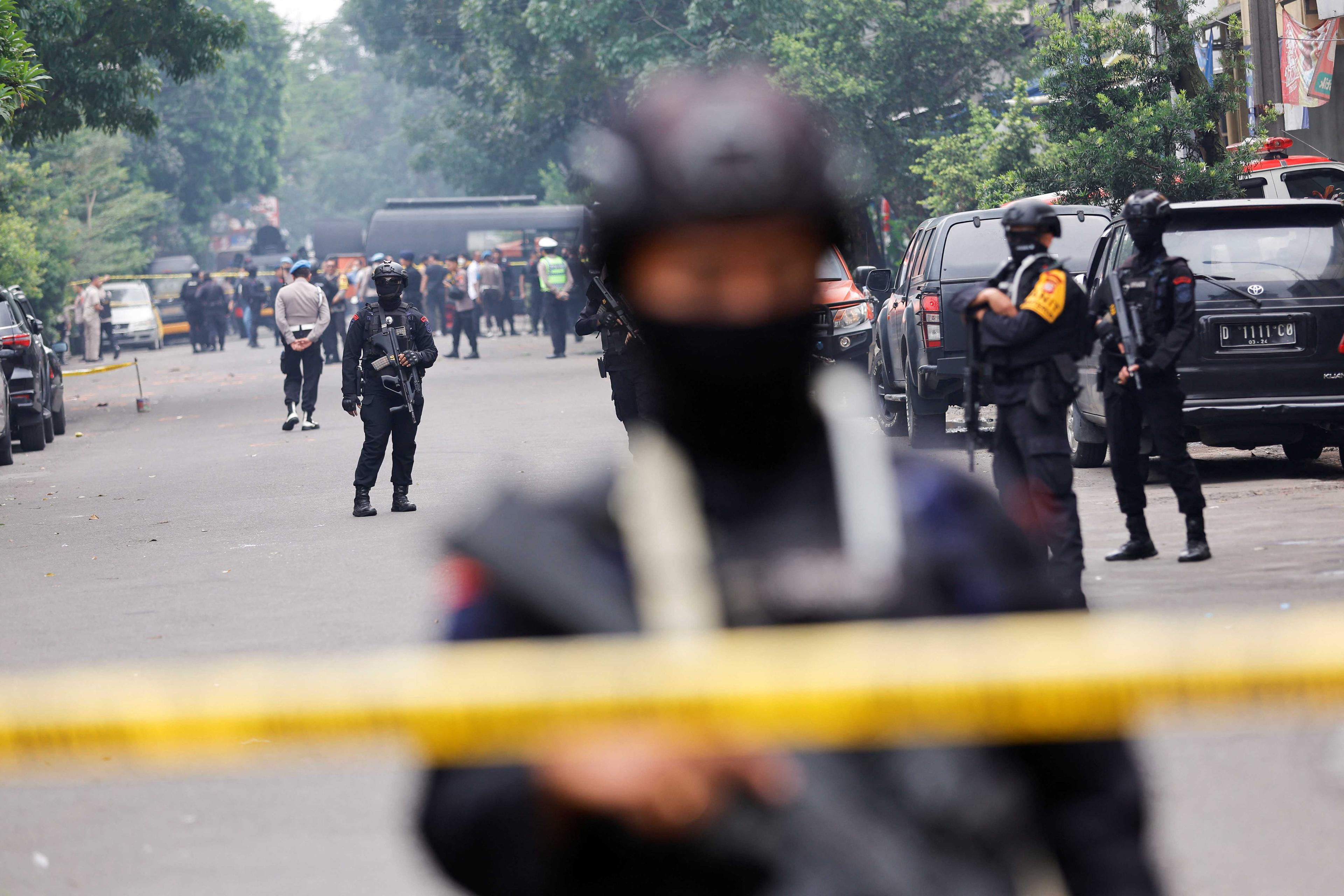 Armed police officers stand guard following a blast at a district police station, that according to authorities was a suspected suicide bombing, in Bandung, West Java province, Indonesia, Dec 7. Photo: Reuters