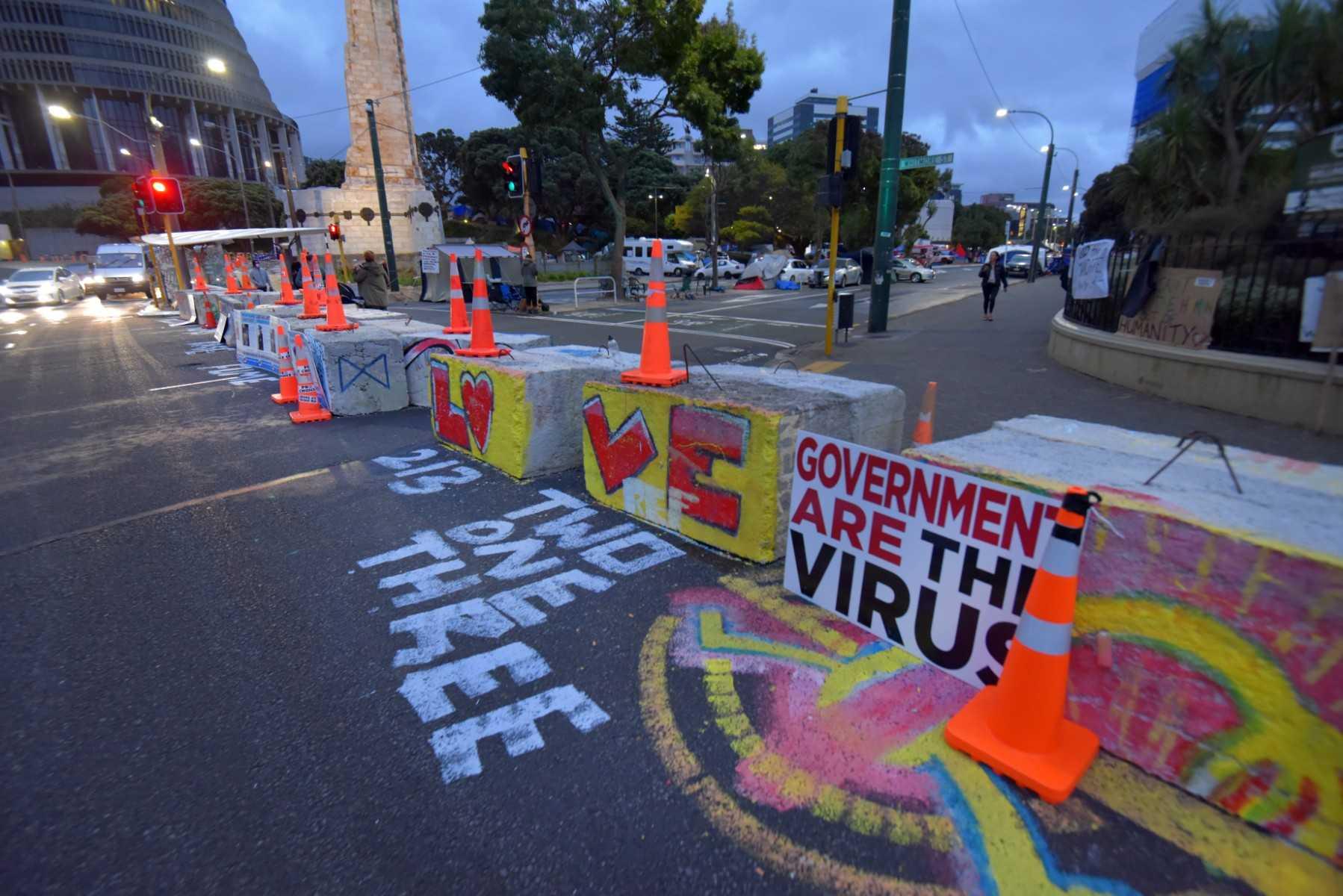 Messages left by protesters against Covid-19 vaccine manadates and restrictions are seen outside parliament grounds in Wellington on March 2. Photo: AFP
