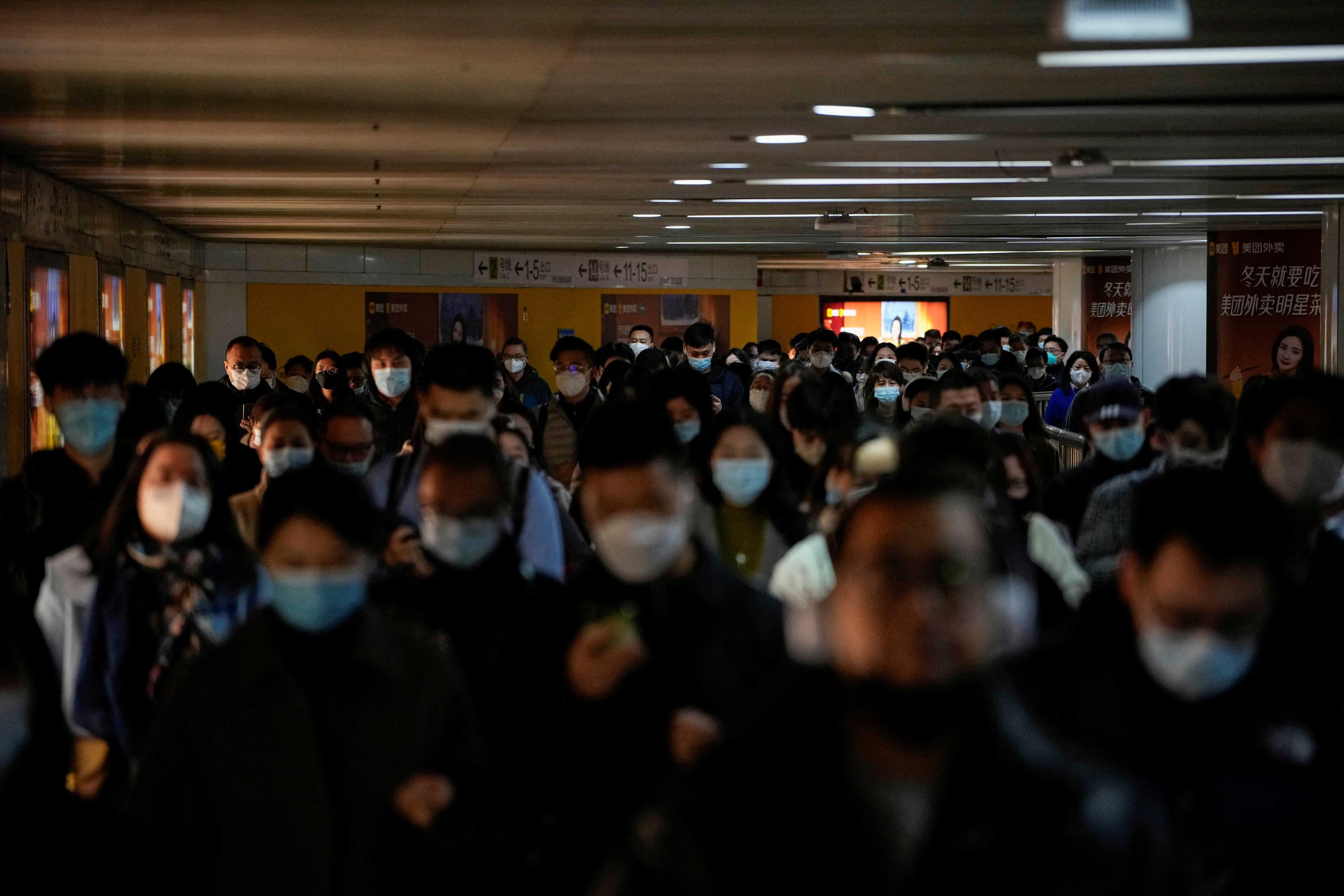 People wearing face masks walk in a subway station, as Covid-19 outbreaks continue in Shanghai, China, Dec 8. Photo: Reuters