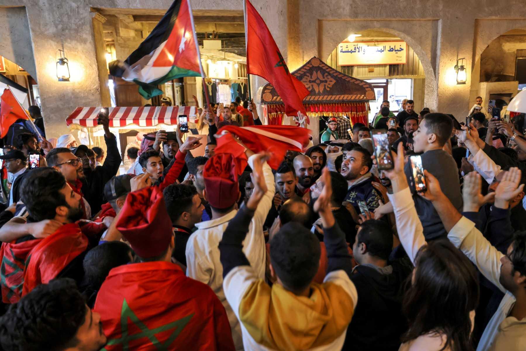 Penyokong meraikan kemenangan Maghribi ke atas Portugal semalam di Souq Waqif di Doha, Qatar. Gambar: AFP
