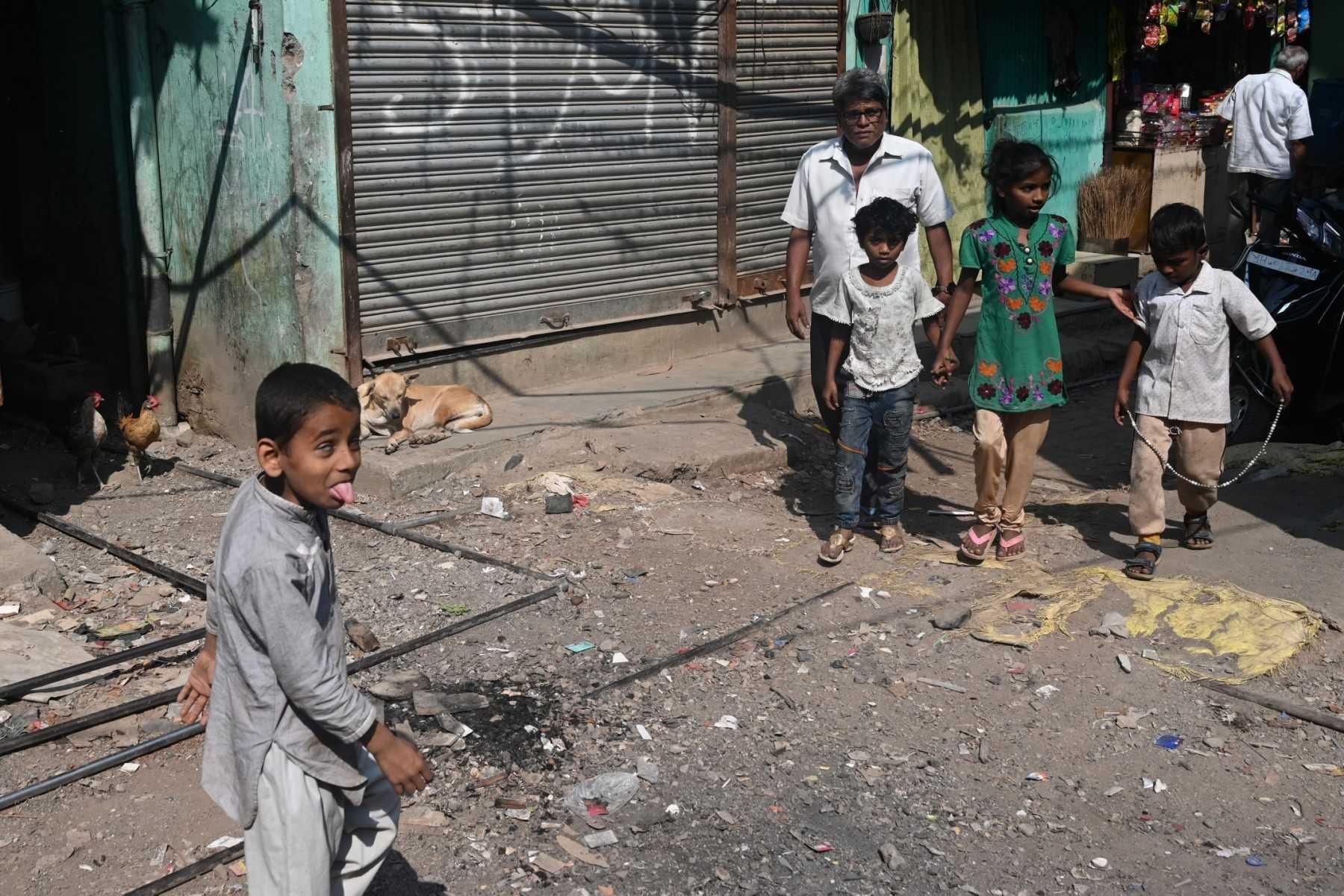 A boy walks through a slum in Mumbai on Nov 23. Photo: AFP