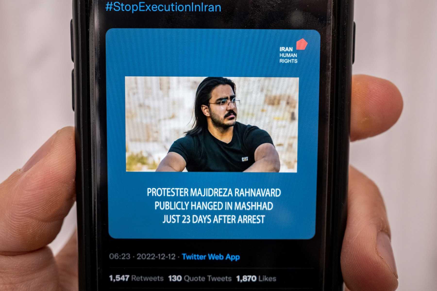 A person in the Cypriot capital Nicosia checks a mobile phone on Dec 12, displaying a tweet about the execution announced by Iranian authorities of Majidreza Rahnavard, the second capital punishment linked to nearly three months of protests. Photo: AFP