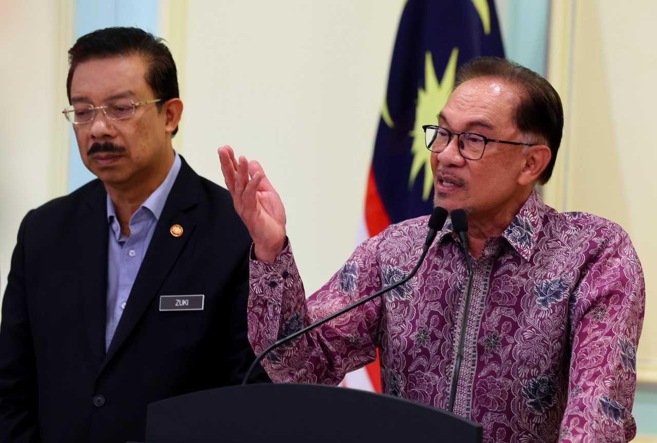Prime Minister Anwar Ibrahim with Chief Secretary to the Government Mohd Zuki Ali (left) at a press conference in Putrajaya on Nov 27. Photo: Bernama