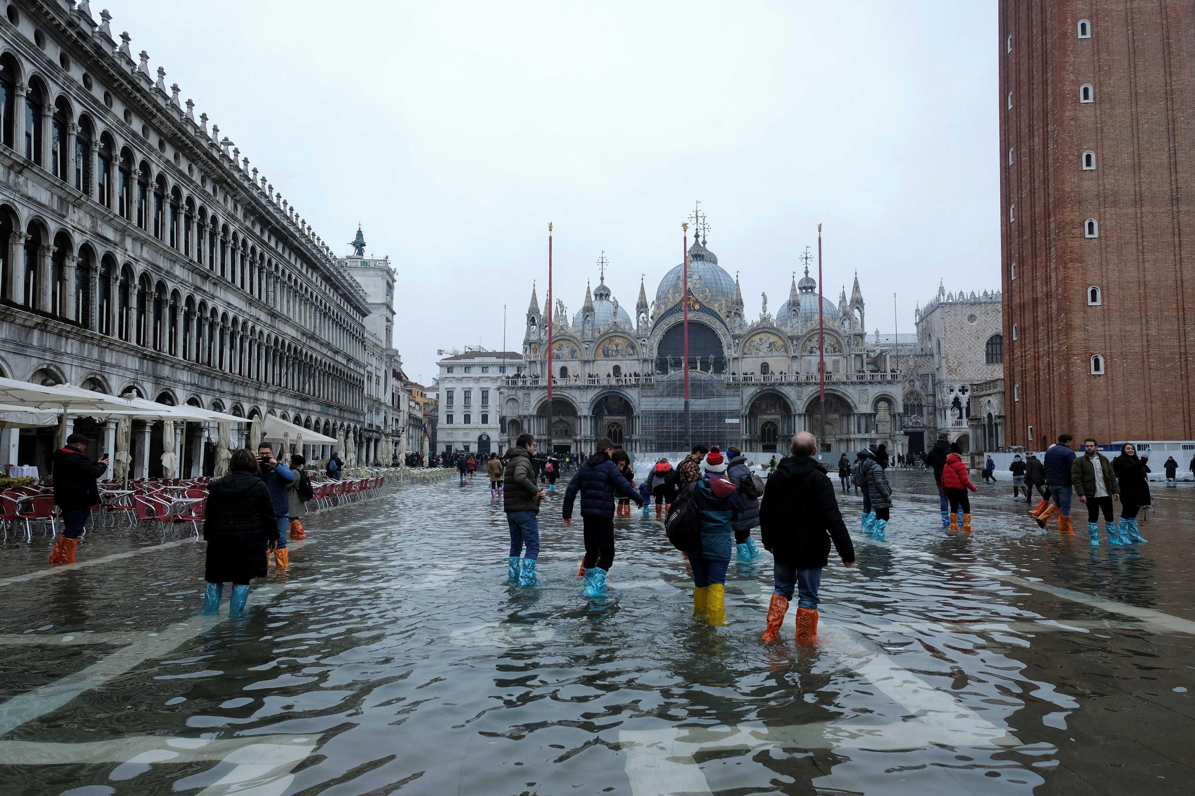 People wade through water in a flooded St Mark's Square during seasonal high water in Venice, Italy, Dec 10. Photo: Reuters