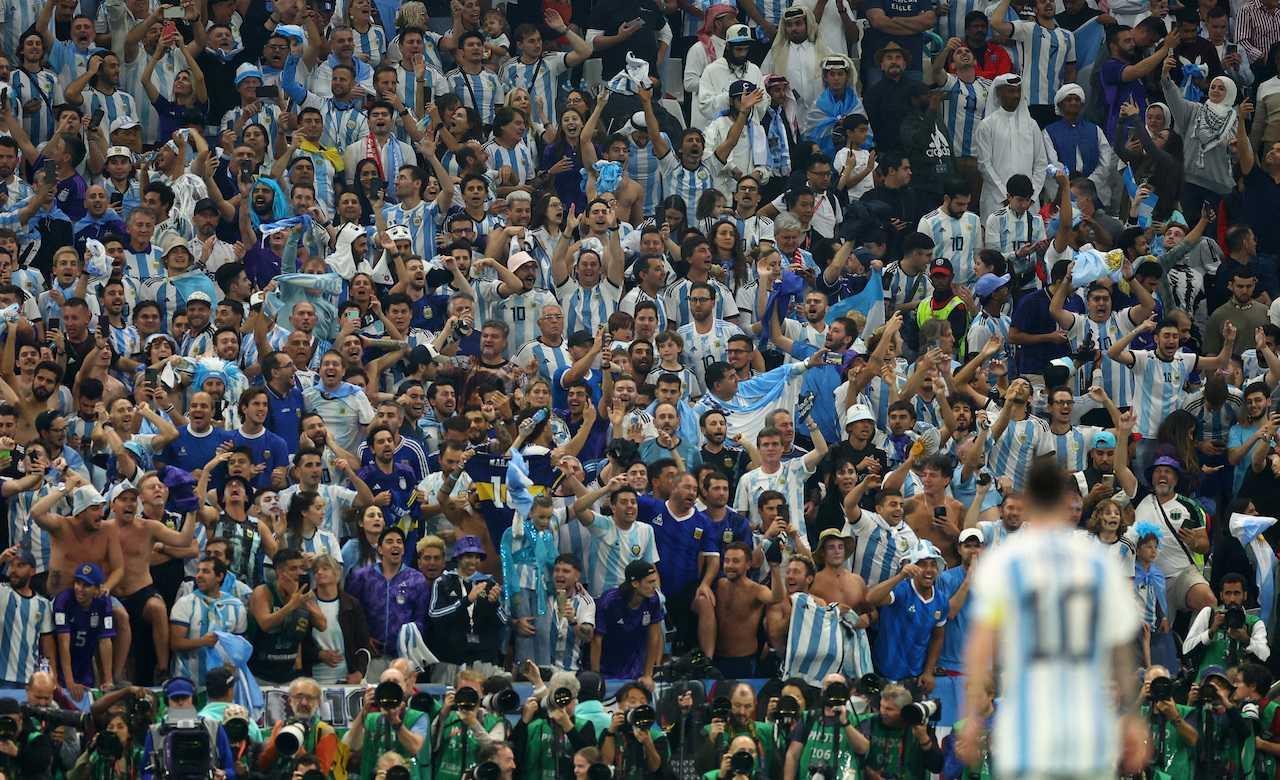 Argentina fans in the stands react during a match with Lionel Messi pictured in the foreground at Lusail Stadium in Lusail, Qatar, Dec 13. Photo: Reuters