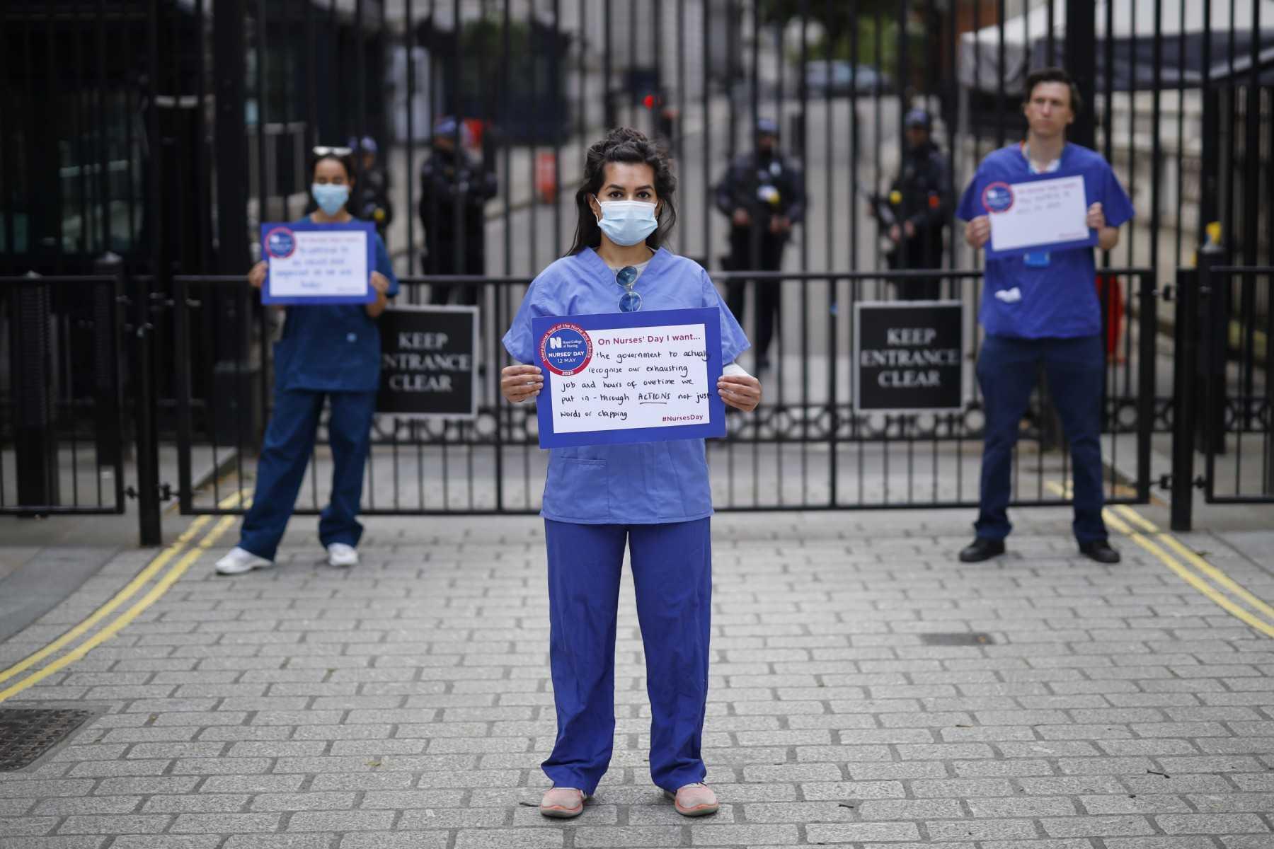 Nurses who work at central London hospitals protest with placards outside Downing Street in central London on May 13, 2020. Photo: AFP 