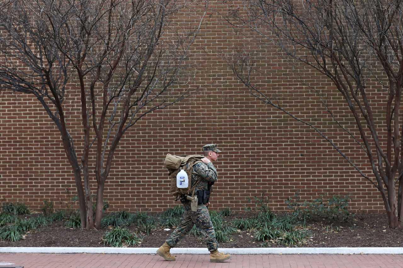 A member of the US Marines walks near Barracks Row, a military housing unit in Washington, Dec 8. Photo: Reuters