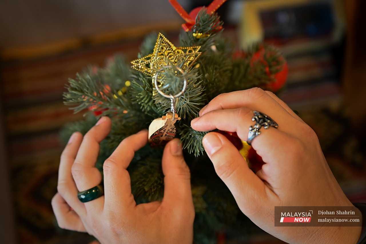 With Christmas just around the corner, he has been busy putting up his miniature tree, decorated with lights and crowned with a tiny sape next to the star. 
