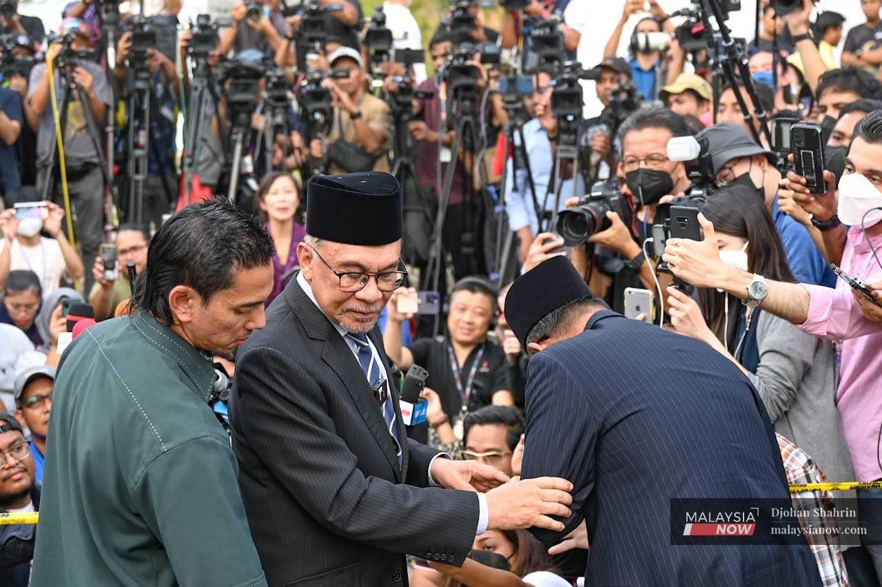 Pakatan Harapan chairman Anwar Ibrahim leaves after a press conference at which he announced that no decision had been made on the prime minister's appointment. 