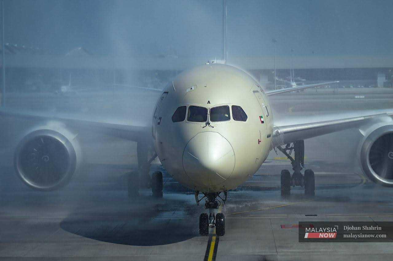 An Etihad plane from Abu Dhabi is sprayed with water upon its arrival at KLIA in Sepang, after the reopening of Malaysia's borders on April 1. 
