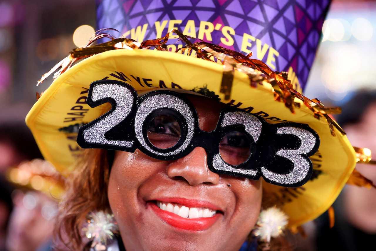 A person wears 2023 glasses during New Year celebrations in Times Square during the first New Year's Eve event without restrictions since the Covid-19 pandemic in New York City, Dec 31, 2022. Photo: Reuters