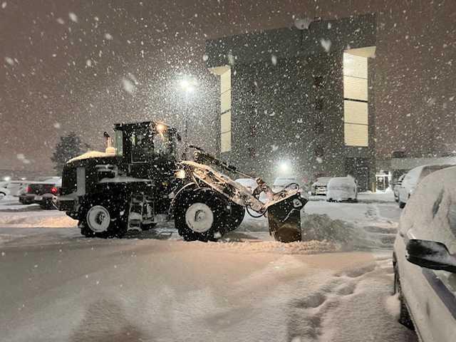 A New York Army National Guard soldier uses a front-end loader to clear snow from the parking lot in Cheektowaga, New York, US Dec 26, 2022, in this handout image by New York National Guard. Photo: Reuters