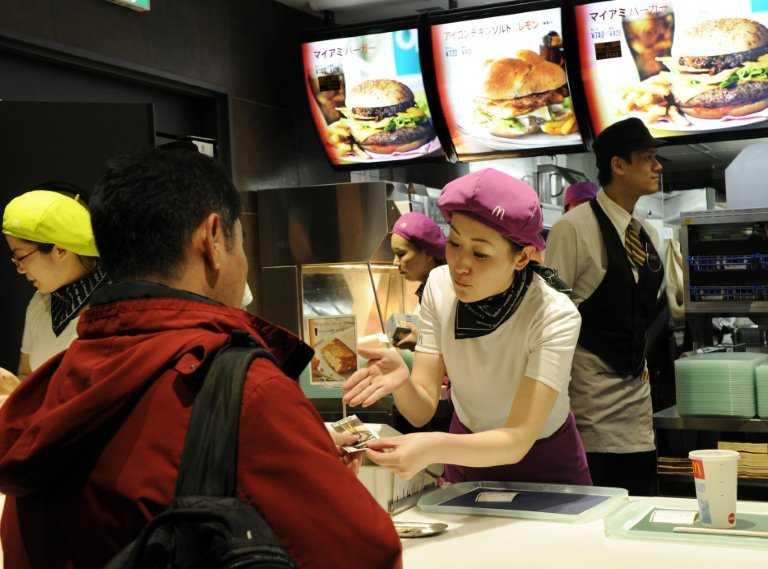 Customers buy fast food at a McDonalds restaurant in Tokyo on Feb 14, 2011. Photo: AFP 