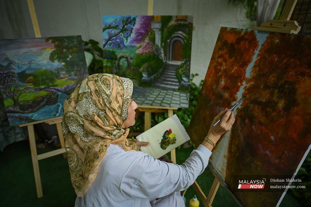 Norhayati has completed nearly 20 paintings since she began in early 2022. Some, she has sold. Others, she donates to a centre for autism in Hulu Kelang. 
