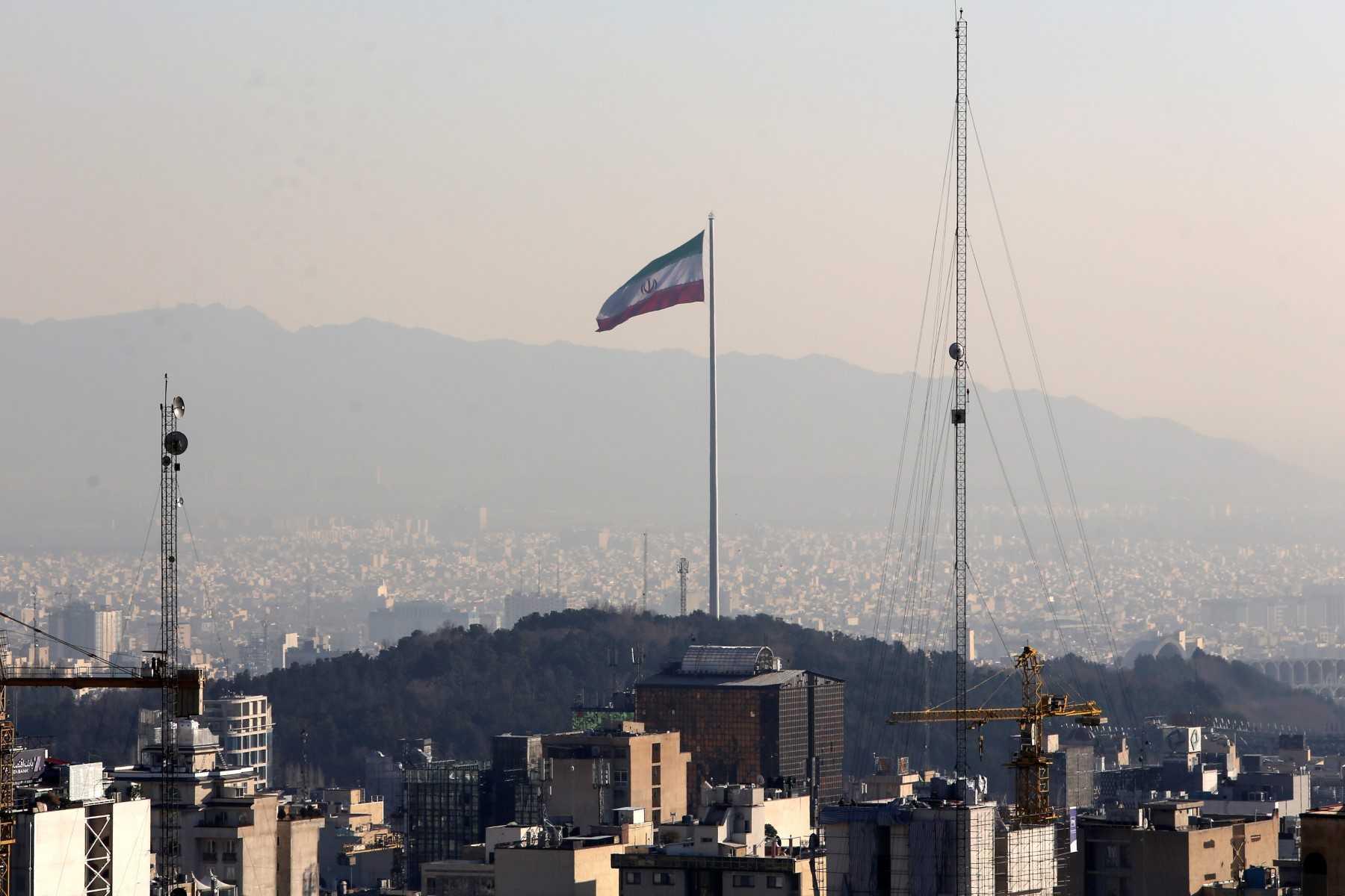 A general view shows the Iranian capital Tehran on Jan 7, with the Iranian flag fluttering in the wind. Photo: AFP 