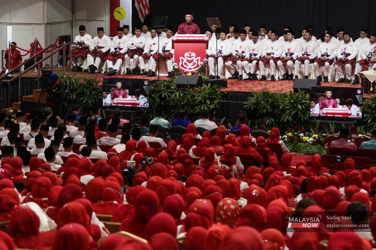 Umno deputy president Mohamad Hasan speaks at the start of the party's 2022 general assembly at the World Trade Centre in Kuala Lumpur today. 
