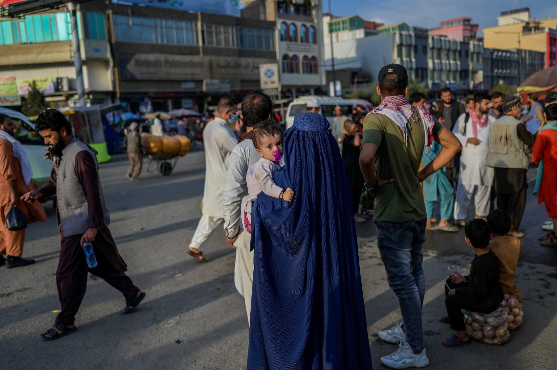 In this picture taken on Sept 22, 2021, people wait for a public bus in Kabul. Photo: AFP 