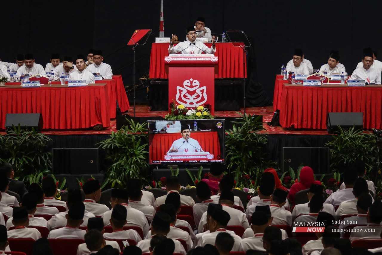 Umno Youth chief Asyraf Wajdi Dusuki speaks at the 2022 general assembly at the World Trade Centre in Kuala Lumpur, Jan 12. 
