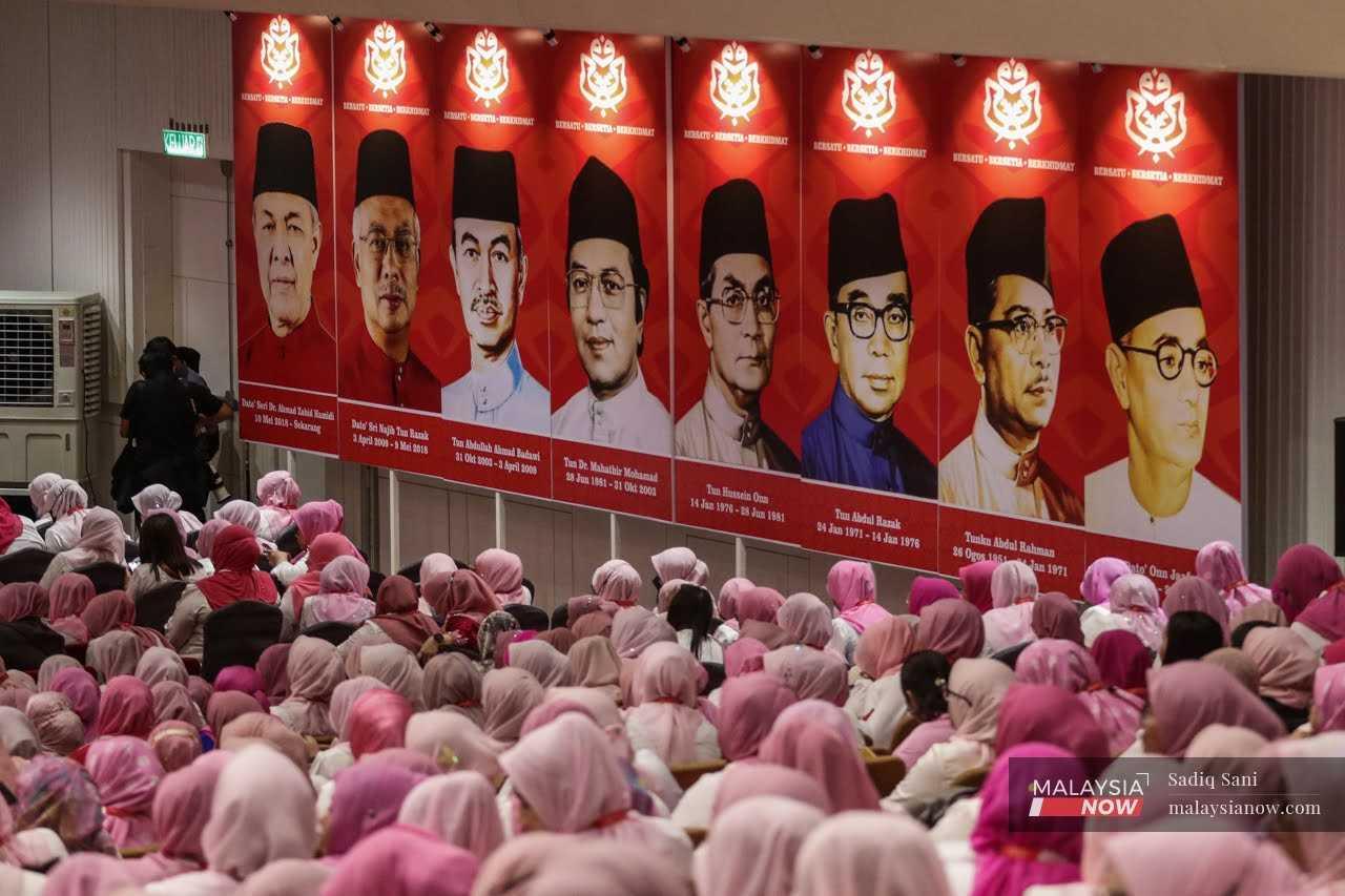 Delegates sit below portraits of Umno presidents during the party's 2022 general assembly at the World Trade Centre in Kuala Lumpur, Jan 11. 
